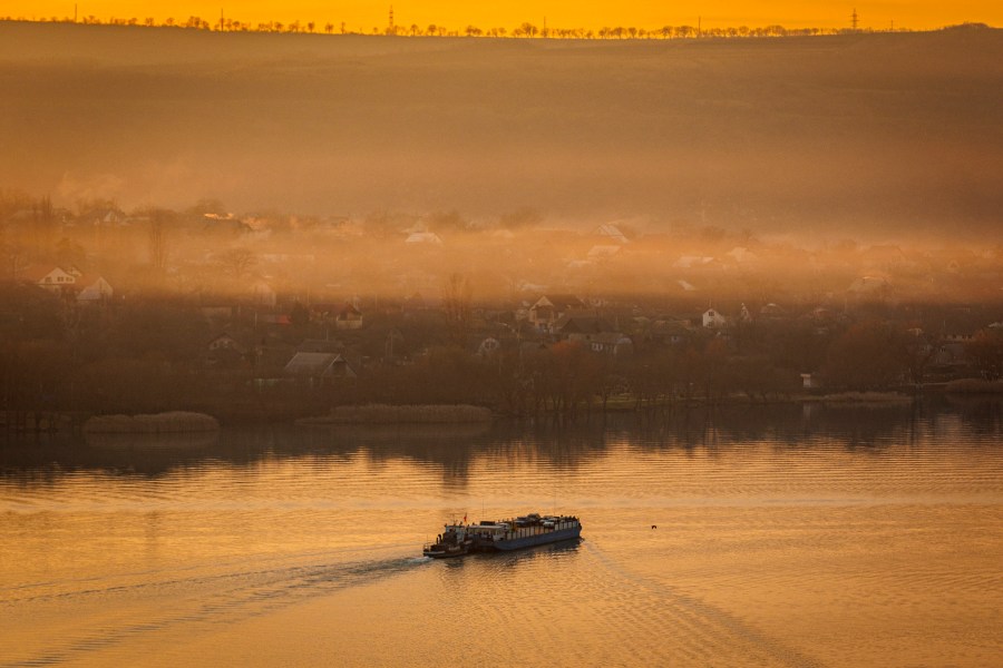 A ferry sails to the left bank of the Dniester river, the border between Moldova and Transnistria, seen from Molovata, Moldova, Wednesday, Jan. 8, 2025. (AP Photo)