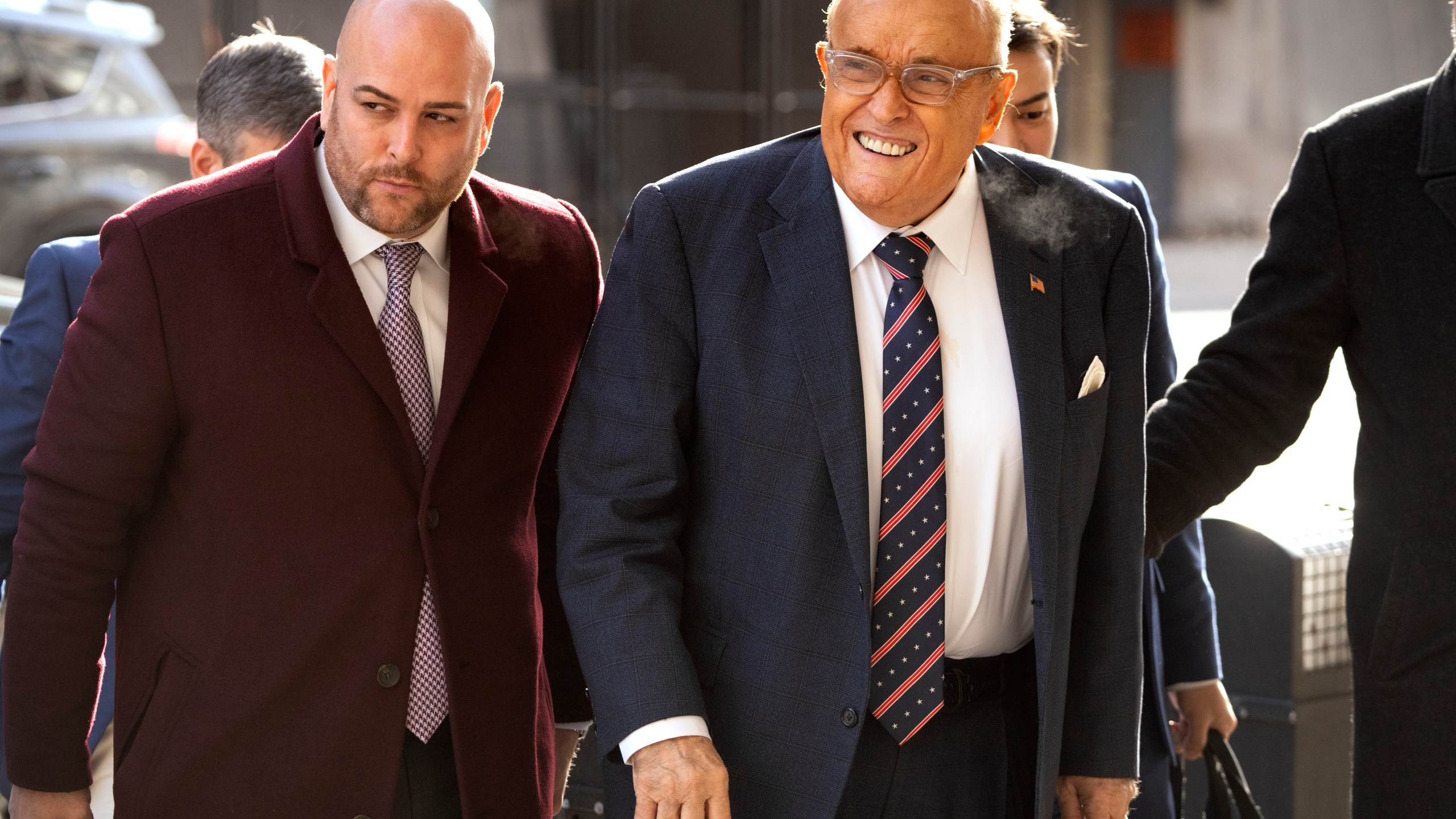 Rudy Giuliani, right, arrives at federal court in Washington, Friday, Jan. 10, 2025. (AP Photo/Mark Schiefelbein)