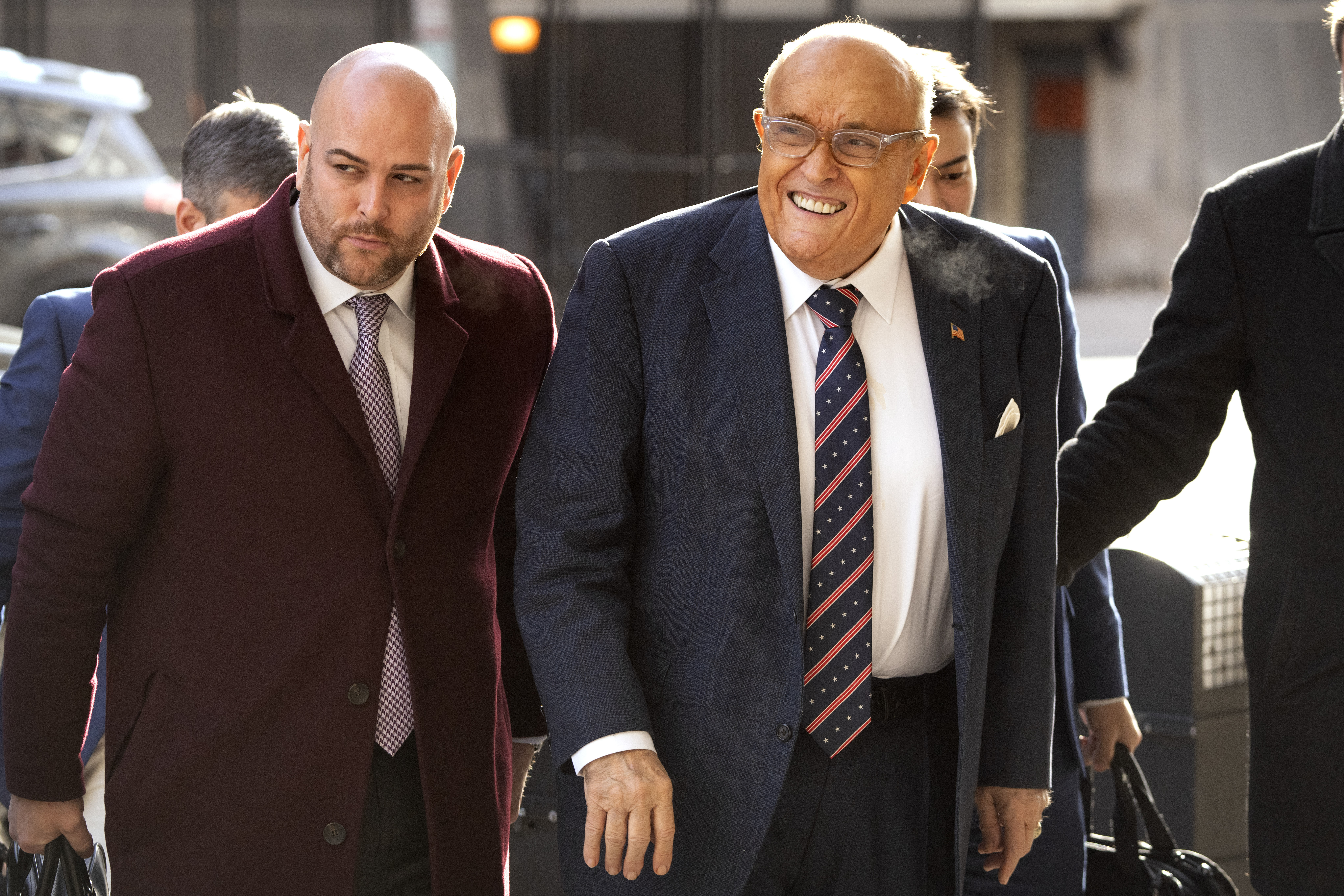 Rudy Giuliani, right, arrives at federal court in Washington, Friday, Jan. 10, 2025. (AP Photo/Mark Schiefelbein)