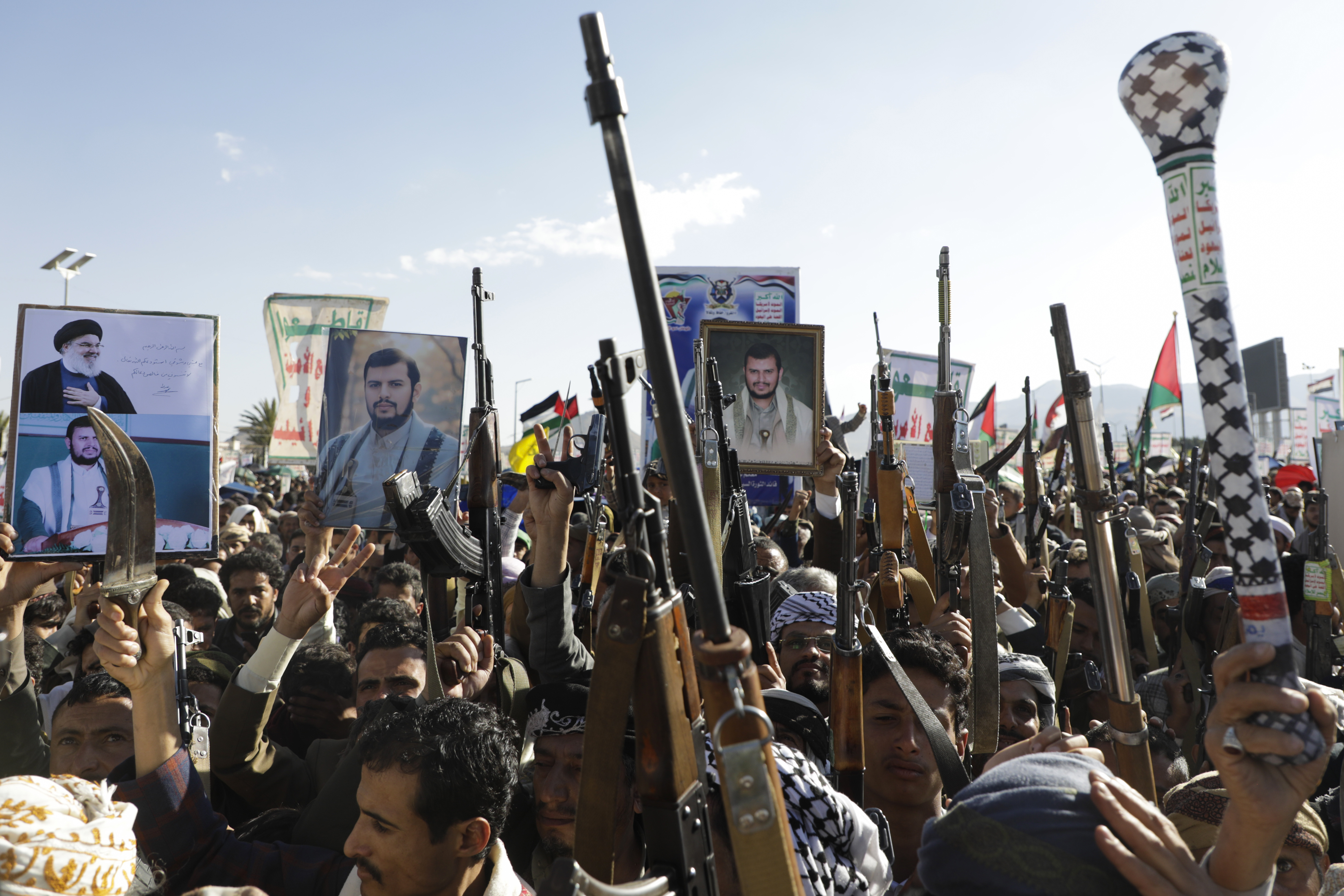 Houthi supporters raise their machine guns during an anti-Israel rally in Sanaa, Yemen, Friday, Jan. 10, 2025. (AP Photo/Osamah Abdulrahman)