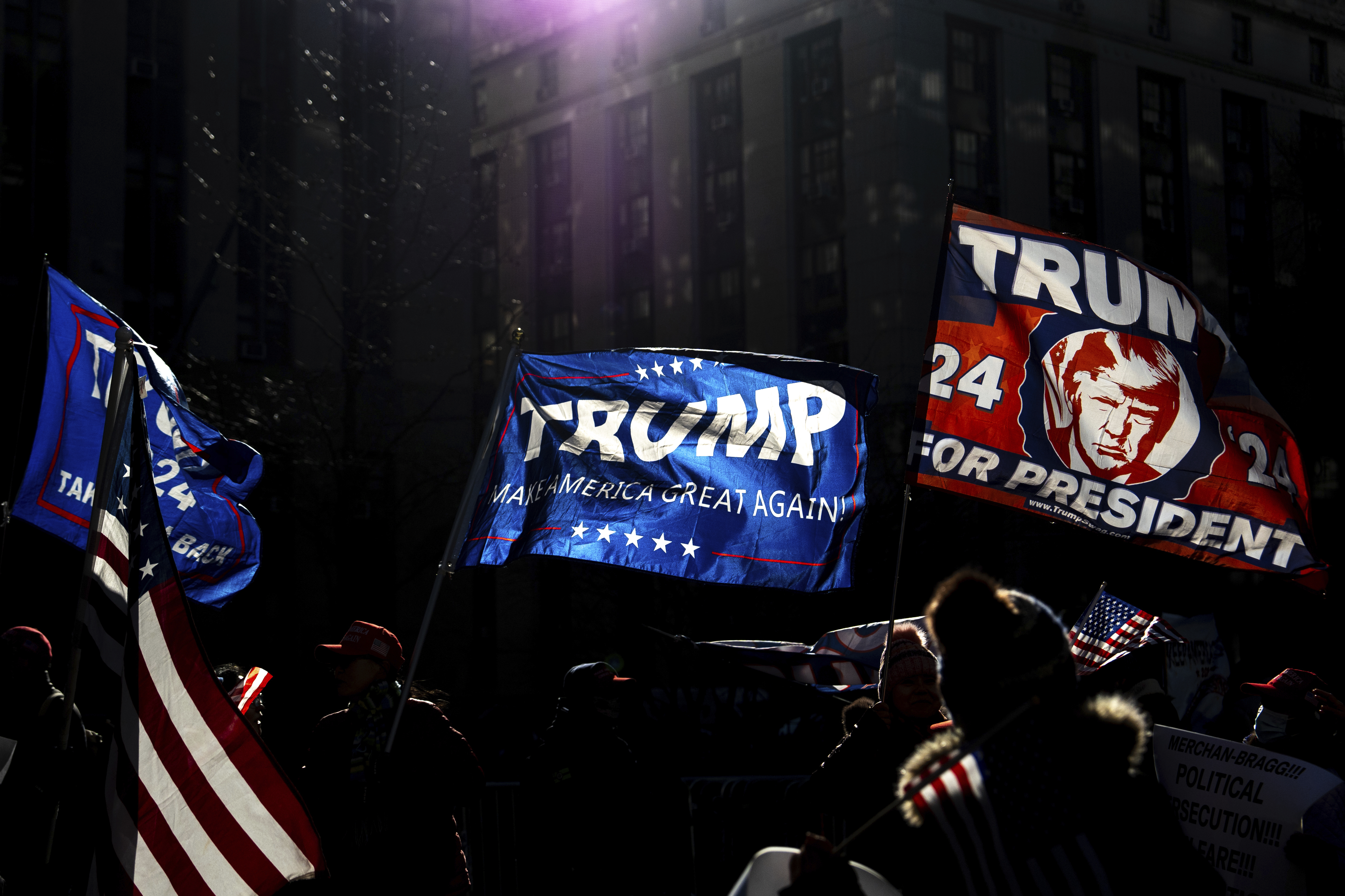 Demonstrators wave Trump flags outside Manhattan criminal court following the sentencing in President-elect Donald Trump's hush money case in New York, Friday, Jan. 10, 2025. (AP Photo/Julia Demaree Nikhinson)