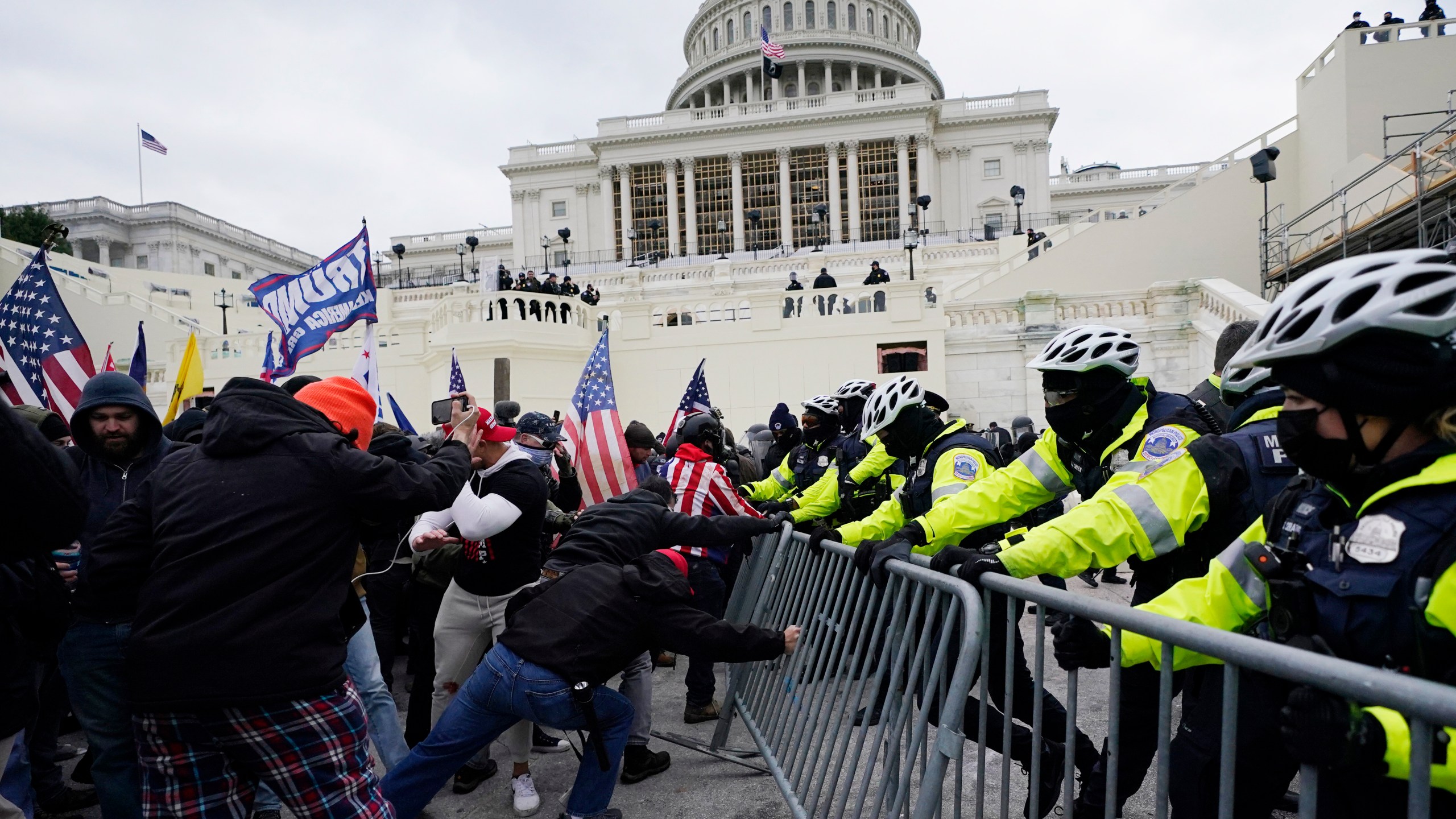 FILE - Insurrectionists loyal to President Donald Trump try to break through a police barrier, Wednesday, Jan. 6, 2021, at the Capitol in Washington. (AP Photo/Julio Cortez, File)