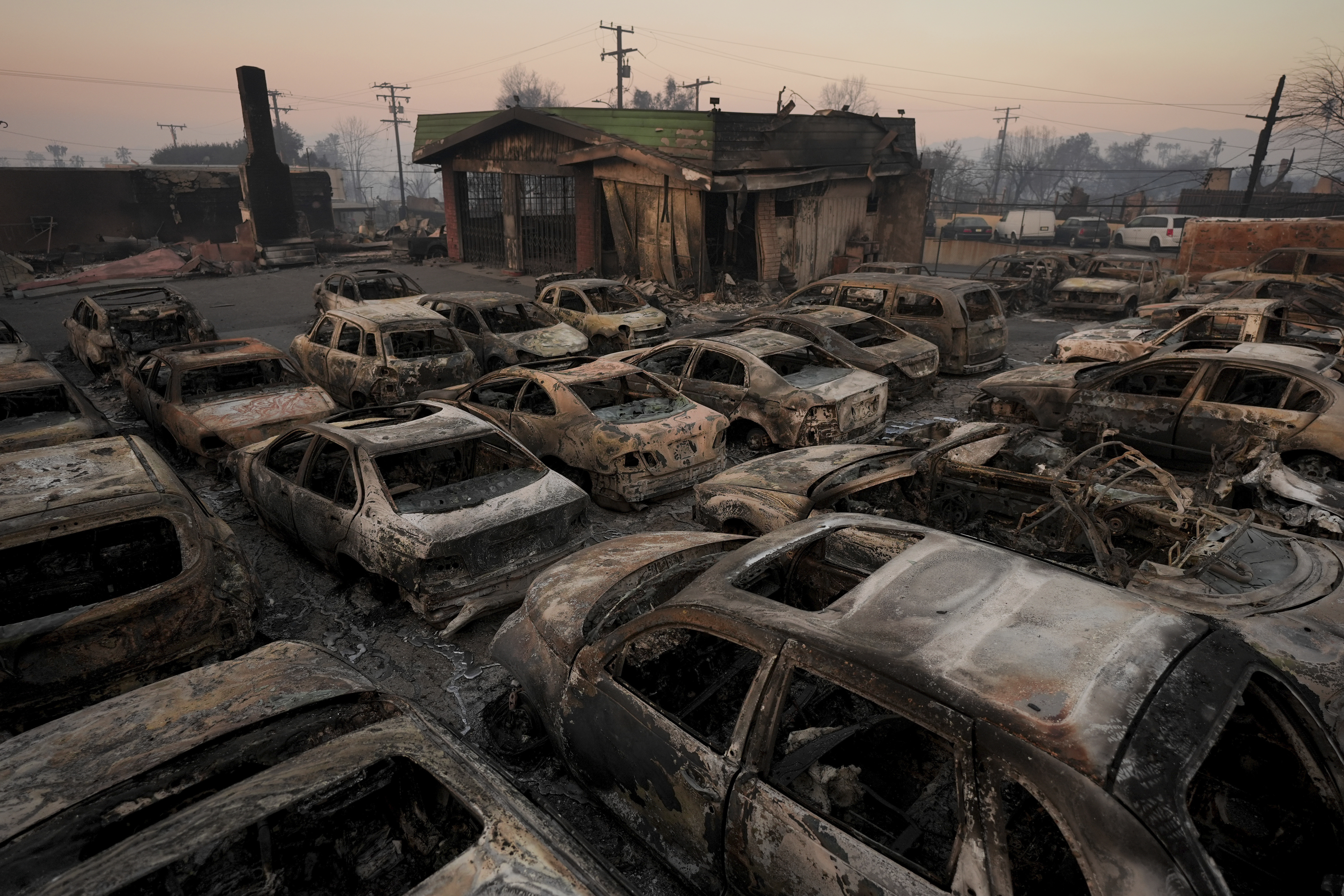 Cars are left charred inside a dealership in the aftermath of the Eaton Fire Friday, Jan. 10, 2025 in Altadena, Calif. (AP Photo/Jae C. Hong)