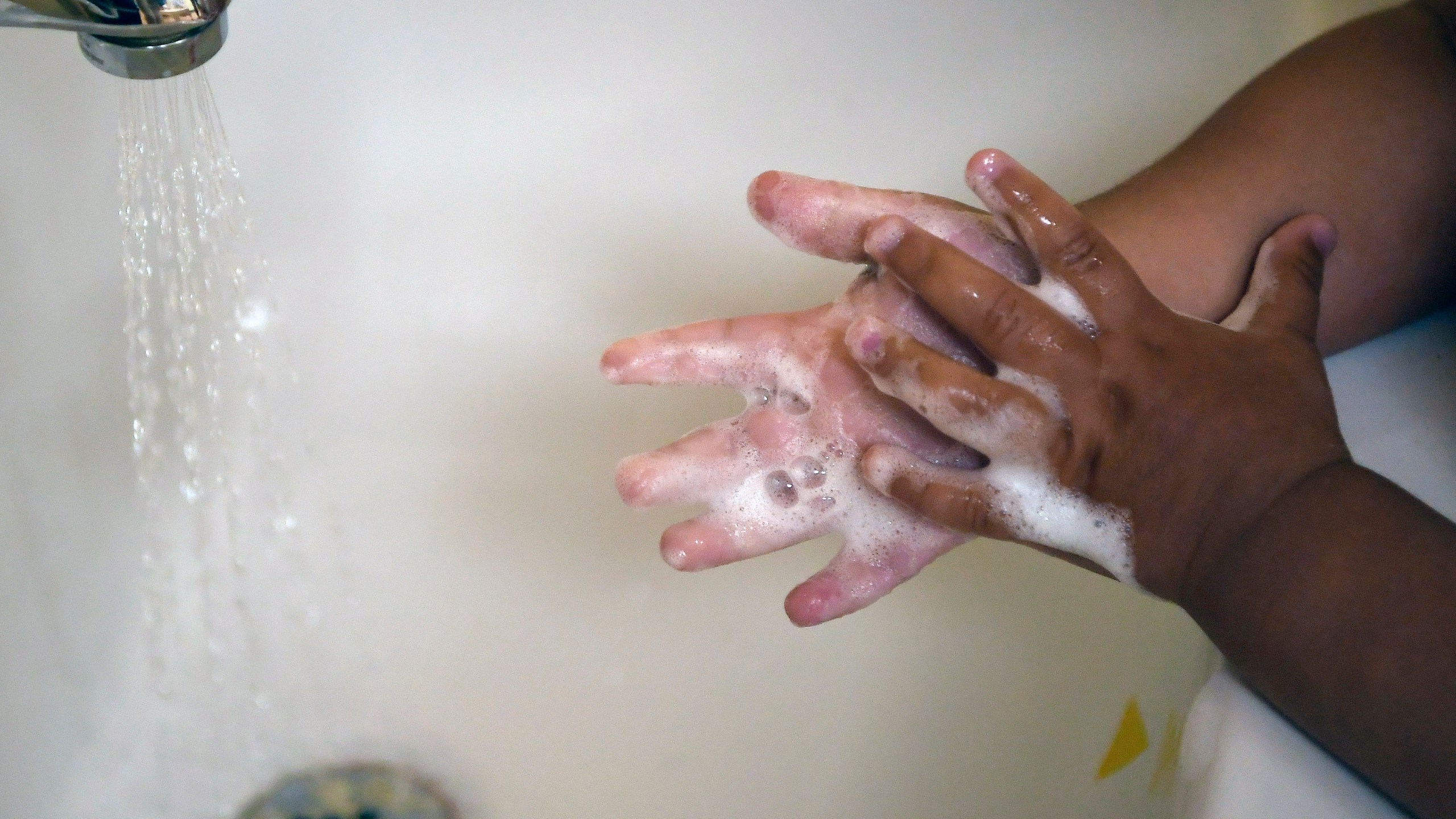 FILE - A child washes her hands at a day care center in Connecticut on Thursday Aug. 27, 2020. (AP Photo/Jessica Hill, File)