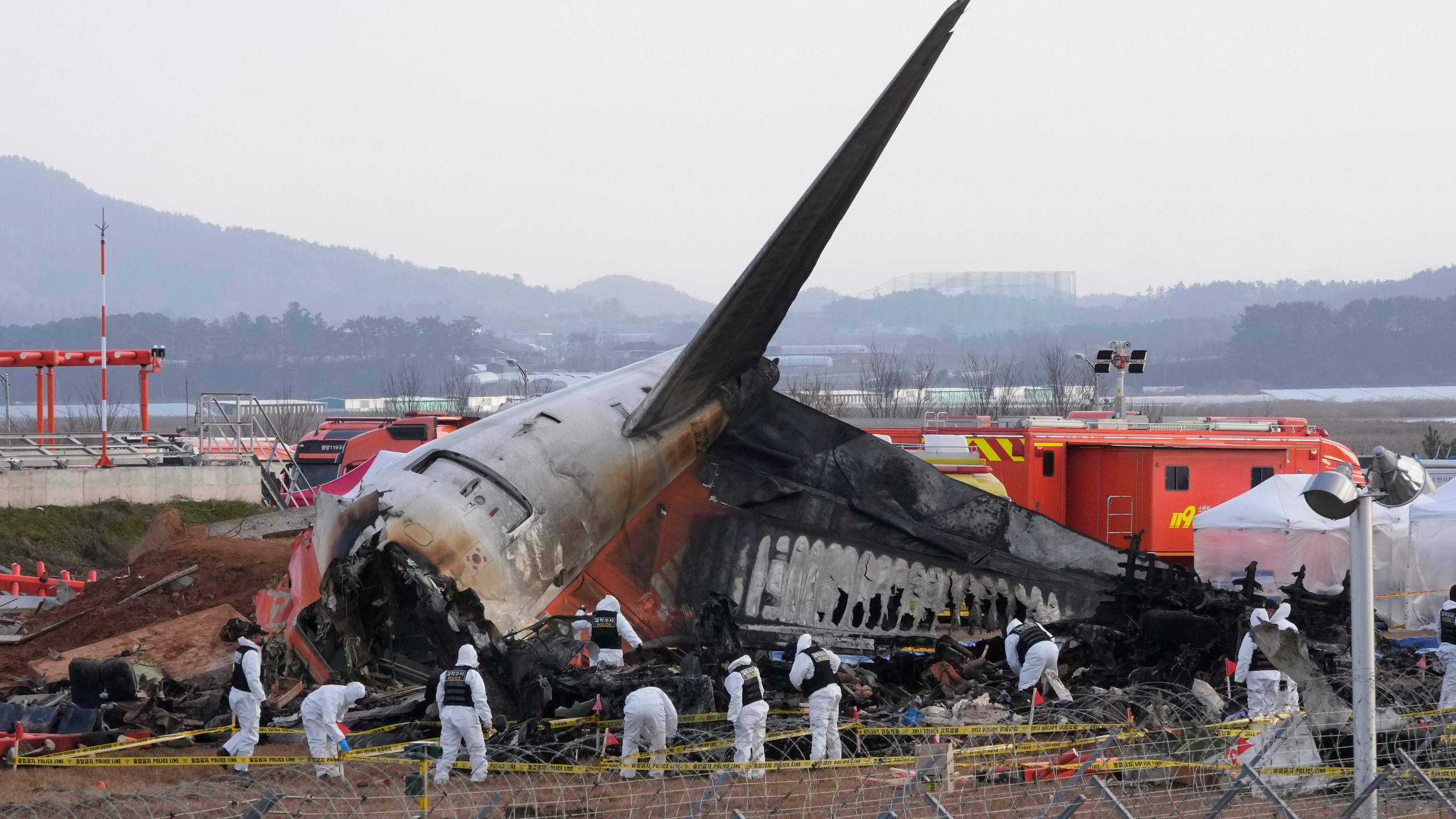 FILE - Rescue team members work at the site of a plane crash at Muan International Airport in Muan, South Korea on Dec. 31, 2024. (AP Photo/Ahn Young-joon, File)