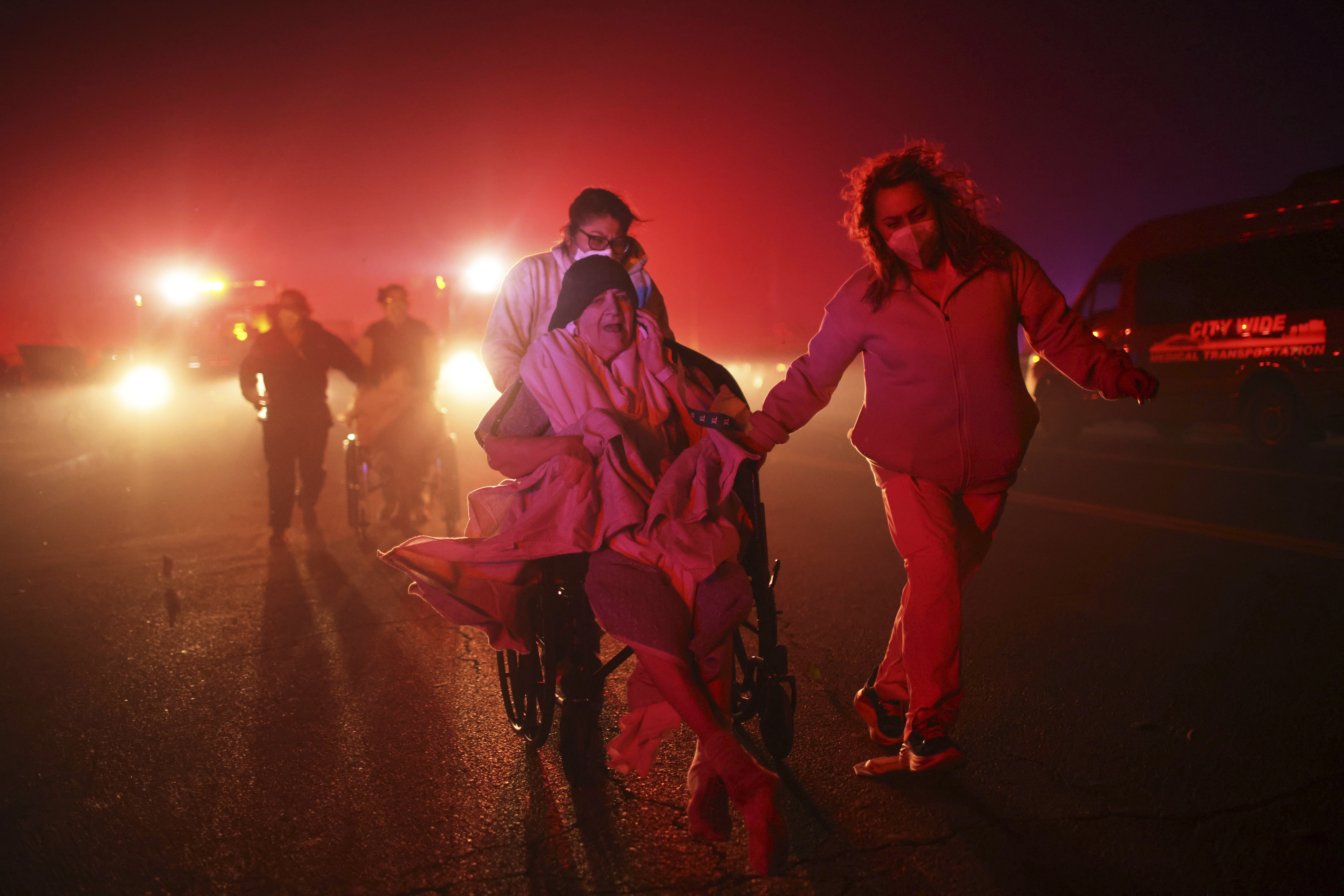 FILE - Residents of a senior center are evacuated as the Eaton Fire approaches Jan. 7, 2025, in Altadena, Calif. (AP Photo/Ethan Swope, File)