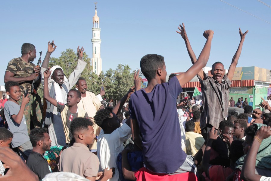 People celebrate following the reports that, Sudan's army had entered the central city of Wad Madani and pushed out its paramilitary rivals the Rapid Support Forces (RSF), in Merowe, Sudan, Saturday, Jan.11, 2025. (AP Photo/Marwan Ali)