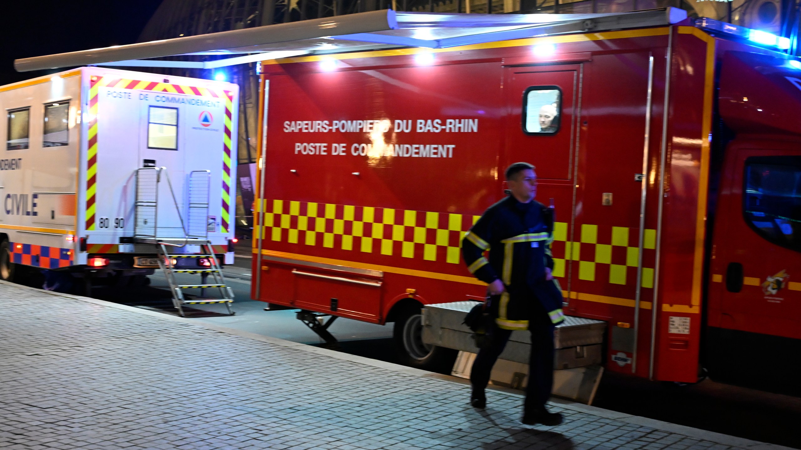 A firefighter rushes to the train station after two trams collided, injuring dozens of people, though none critically, firefighters said, Saturday, Jan. 11, 2025 in Strasbourg, eastern France. (AP Photo/Pascal Bastien)