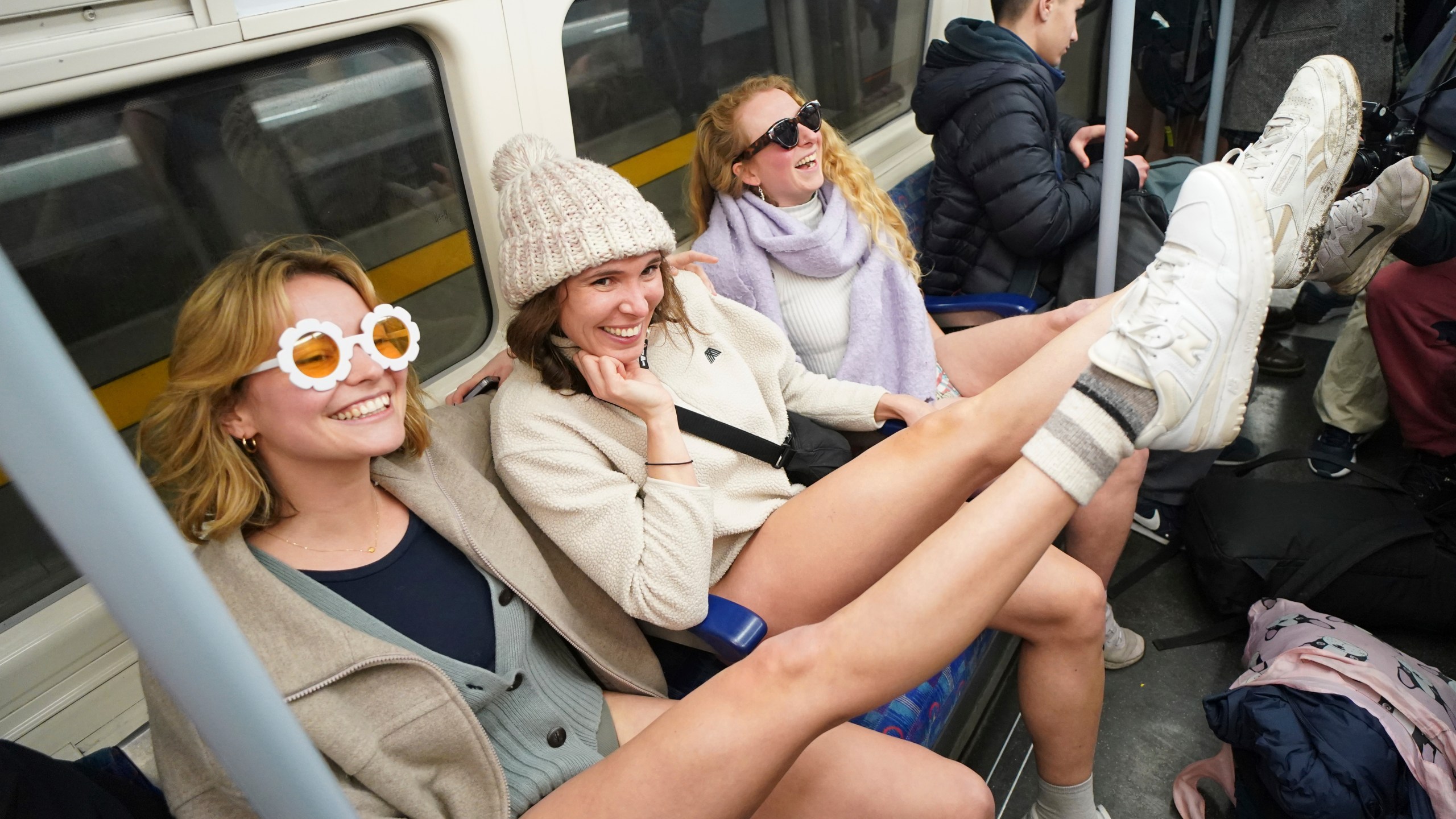 People on board a tube as they take part in the annual event "No Trousers Tube Ride" in London, Sunday, Jan. 12, 2025. (AP Photo/Alberto Pezzali)