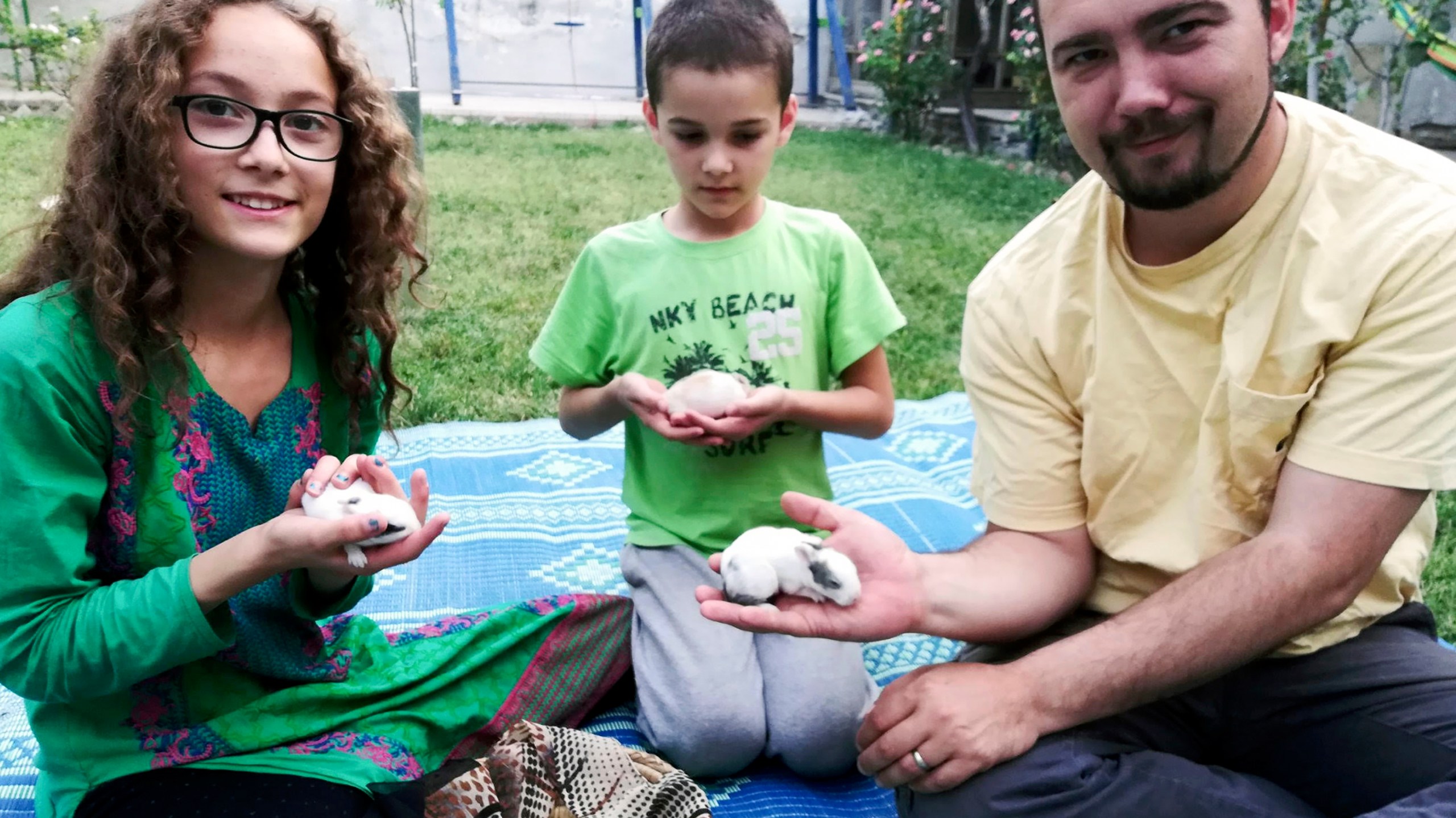 This family photo shows Ryan Corbett holding rabbits with his daughter Miriam and son Caleb in Kabul, Afghanistan in 2020. (AP Photo/Anna Corbett)