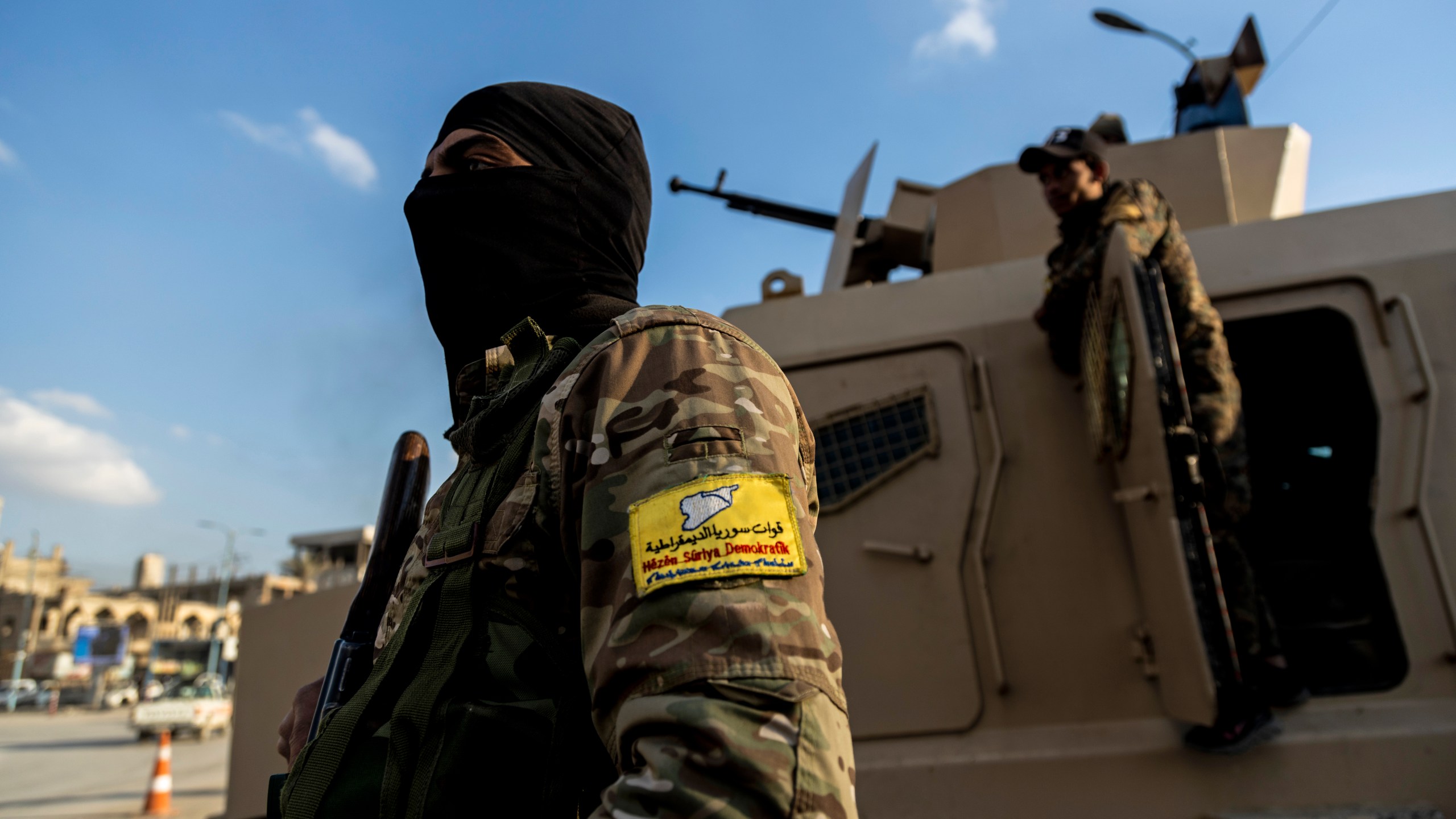 FILE - U.S.-backed Syrian Democratic Forces (SDF) fighters stand guard at Al Naeem Square, in Raqqa, Syria, Monday, Feb. 7, 2022. (AP Photo/Baderkhan Ahmad, File)