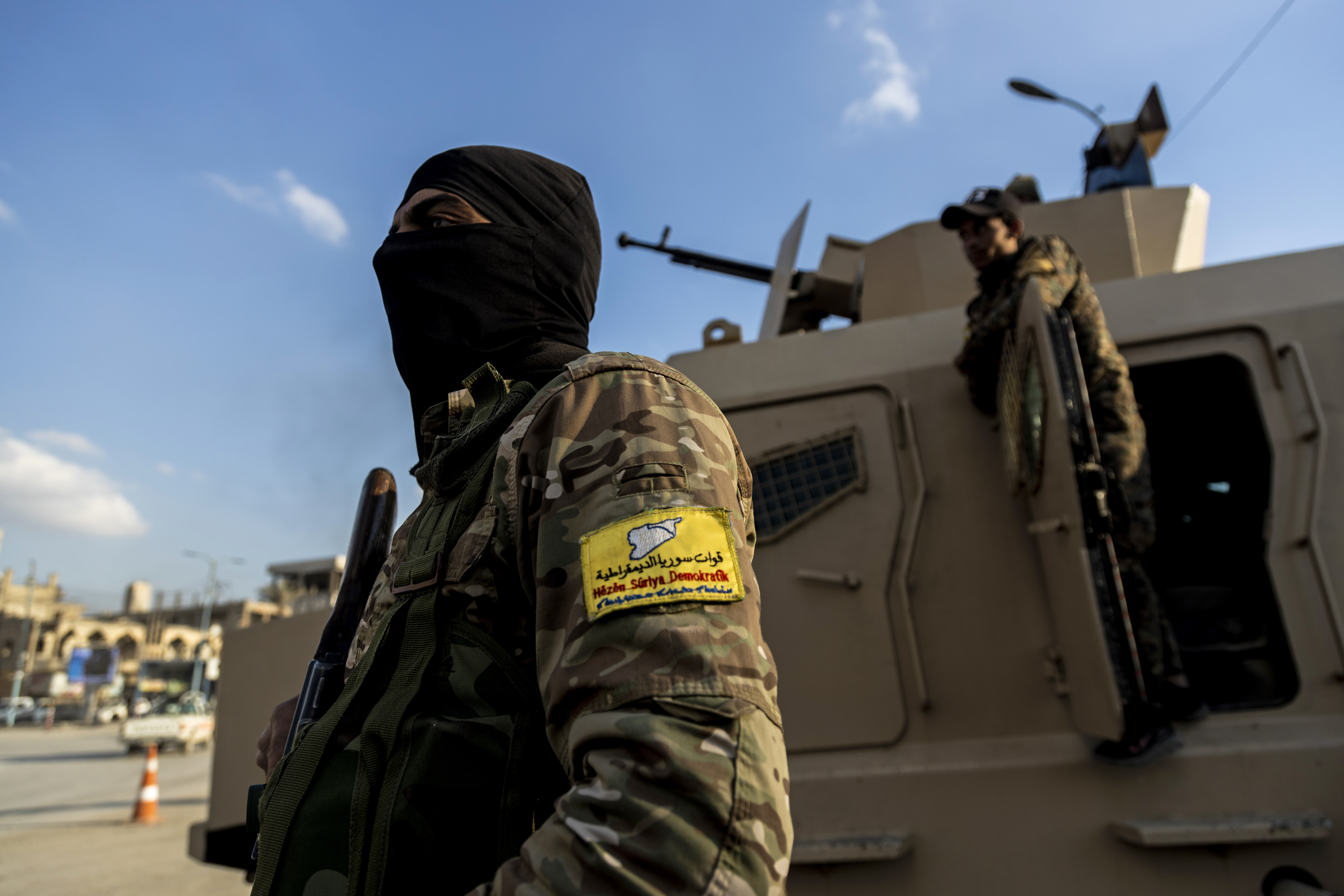 FILE - U.S.-backed Syrian Democratic Forces (SDF) fighters stand guard at Al Naeem Square, in Raqqa, Syria, Monday, Feb. 7, 2022. (AP Photo/Baderkhan Ahmad, File)