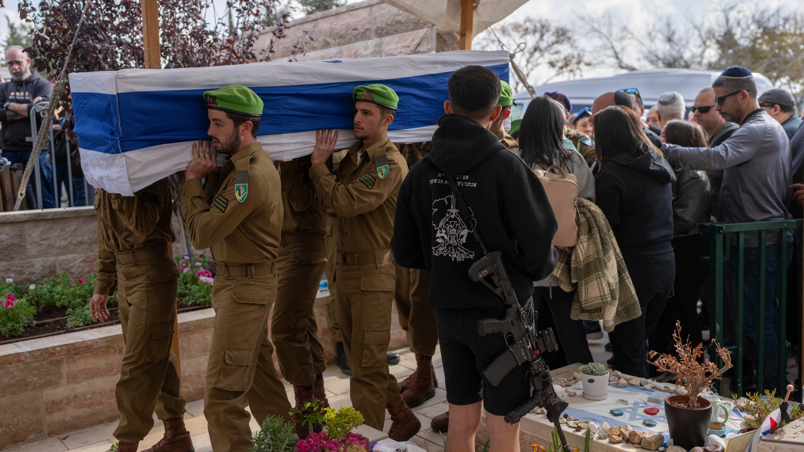 Israeli soldiers and relatives carry the flag-draped casket of Sergeant Yahav Maayan, who was killed in combat in the Gaza Strip, during his funeral at a military cemetery in Modiin, Israel, Sunday, Jan. 12, 2025. (AP Photo/Ohad Zwigenberg)