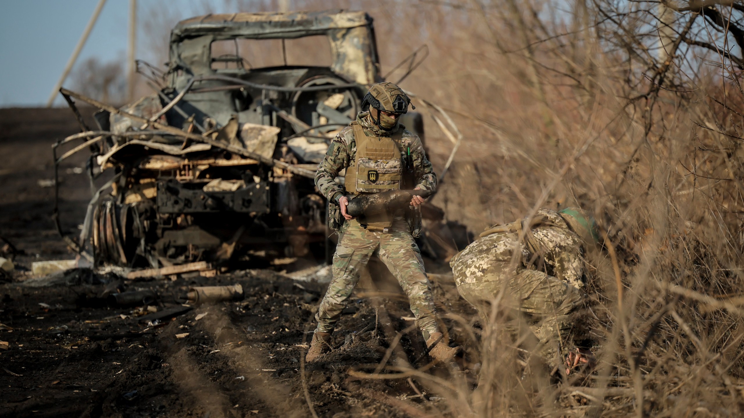 Ukrainian servicemen collect damaged ammunition on the road at the front line near Chasiv Yar town, in Donetsk region, Ukraine, Ukraine, Friday, Jan. 10, 2025. (Oleg Petrasiuk/Ukraine's 24th Mechanised Brigade via AP)