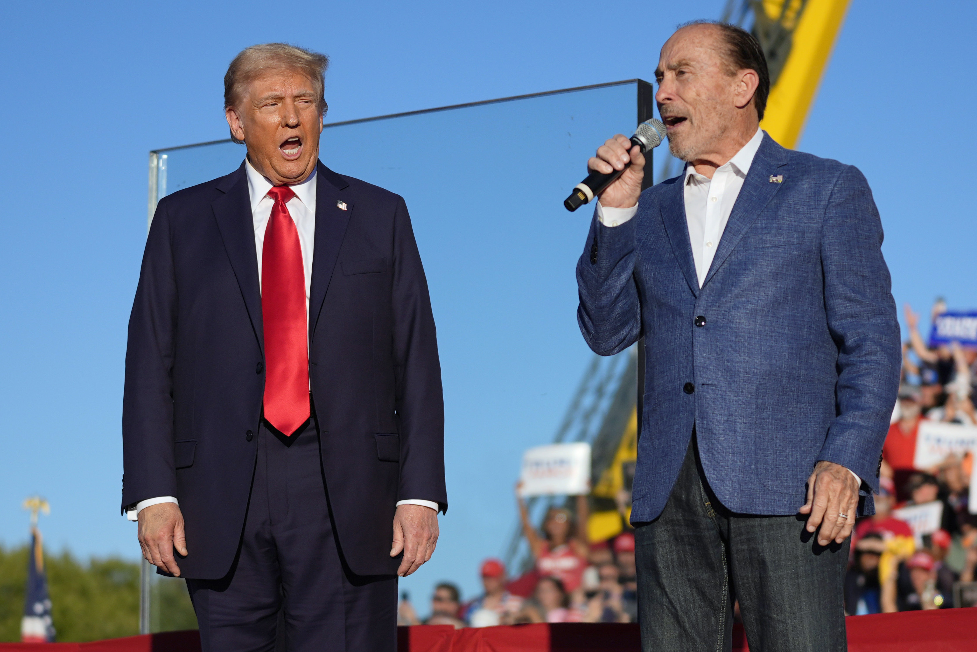 FILE - Republican presidential nominee former President Donald Trump, left, listens to Lee Greenwood at a campaign rally, Oct. 5, 2024, in Butler, Pa. (AP Photo/Evan Vucci, File)