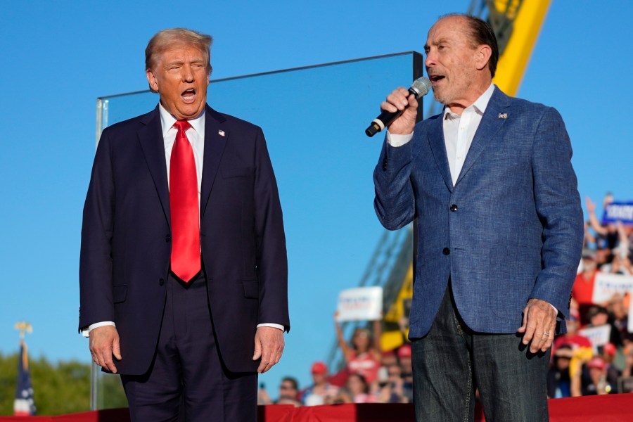 FILE - Republican presidential nominee former President Donald Trump, left, listens to Lee Greenwood at a campaign rally, Oct. 5, 2024, in Butler, Pa. (AP Photo/Evan Vucci, File)