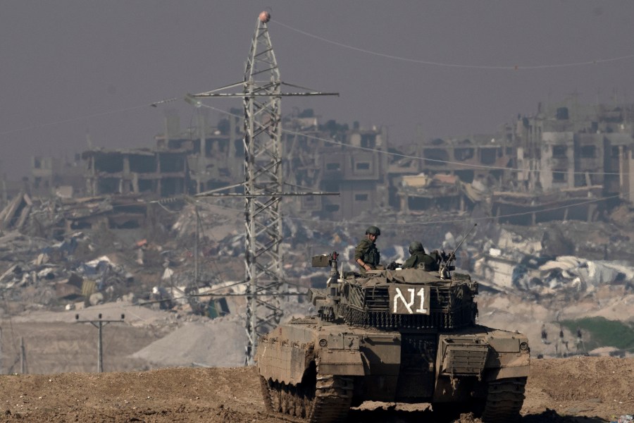 FILE - Israeli soldiers overlook the Gaza Strip from a tank, as seen from southern Israel, on Friday, Jan. 19, 2024. (AP Photo/Maya Alleruzzo, File)