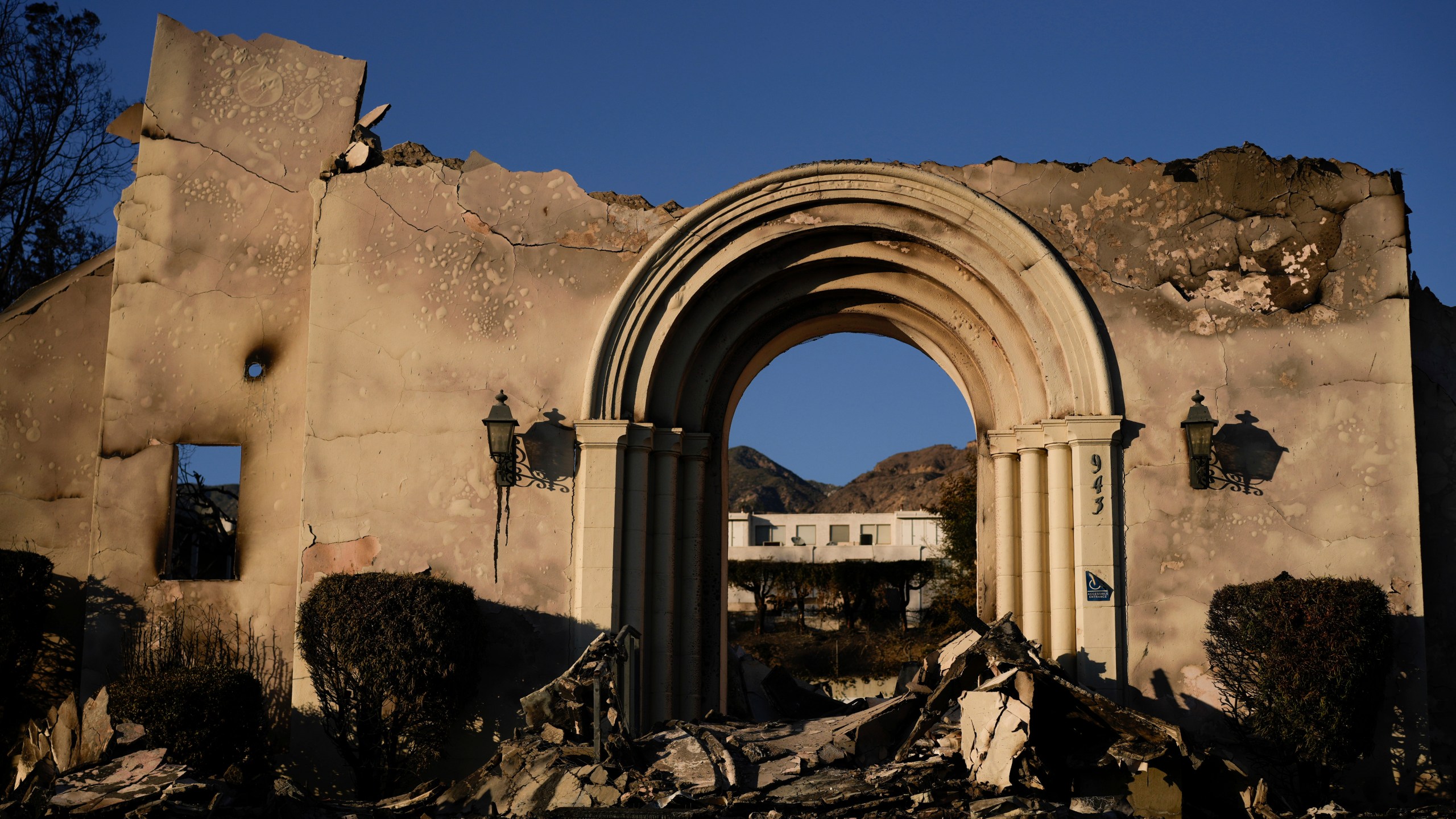 The facade of the Altadena Community Church stands amidst damage from the Eaton Fire on Monday, Jan. 13, 2025, in Altadena, Calif. (AP Photo/Carolyn Kaster)