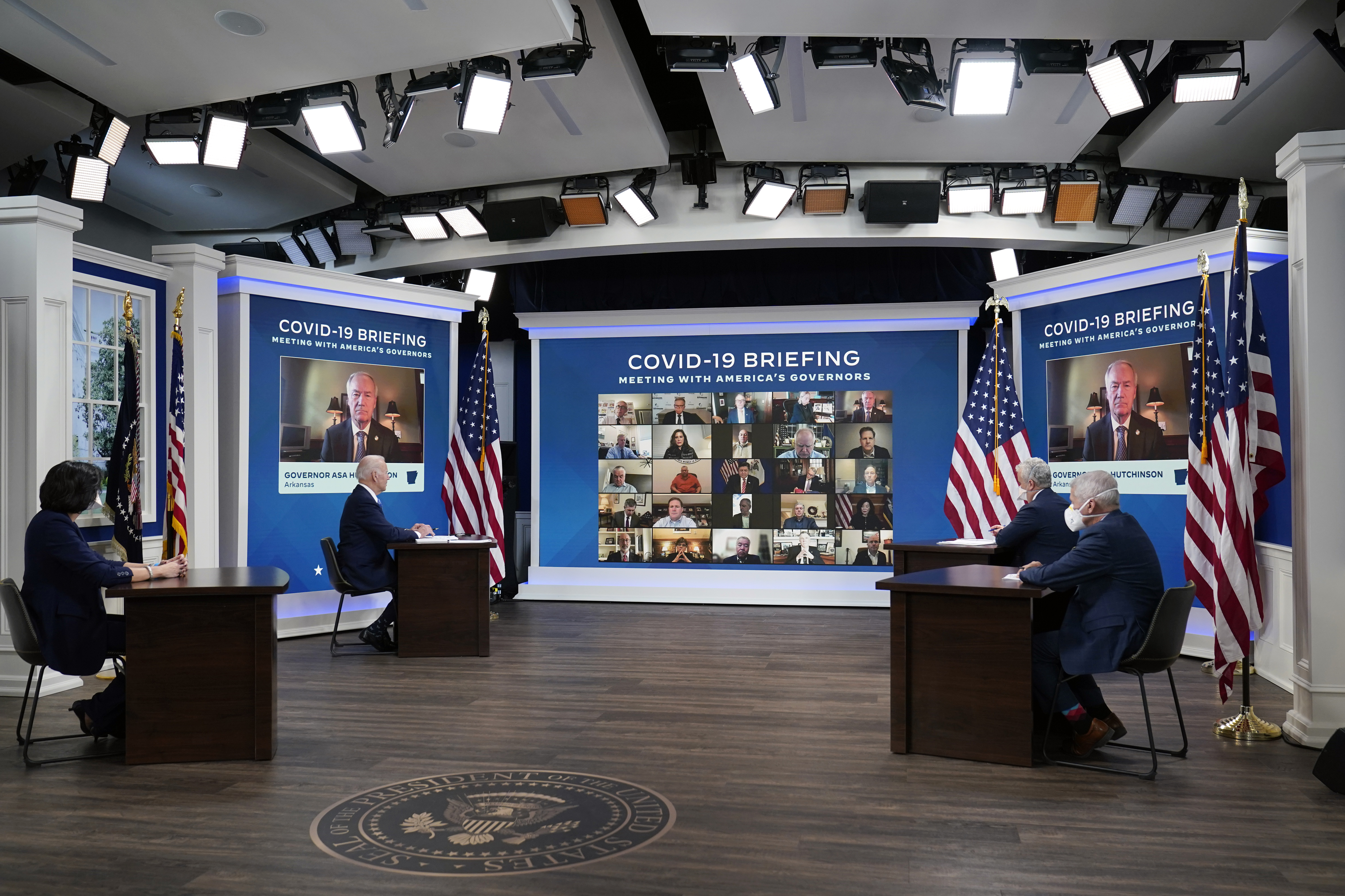 FILE - President Joe Biden, second left, participates in the White House COVID-19 Response Team's regular call with the National Governors Association in the South Court Auditorium in the Eisenhower Executive Office Building on the White House Campus, Monday, Dec. 27, 2021, in Washington. Seated with the President from left Dr. Rochelle Walensky, Director of the Centers for Disease Control and Prevention, Biden, Jeff Zients, COVID-19 Response Coordinator and Dr. Anthony Fauci, White House Chief Medical Advisor and Director of the NIAID. (AP Photo/Carolyn Kaster, File)