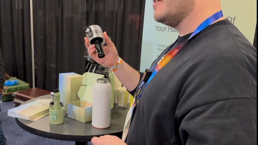 A demonstrator shows how the Roam SodaTop carbonates water directly in a standard water bottle using the special cap during CES Unveiled in Las Vegas. (Jacob Palmer/BestReviews) / BestReviews Genius Products Awards of CES 2025