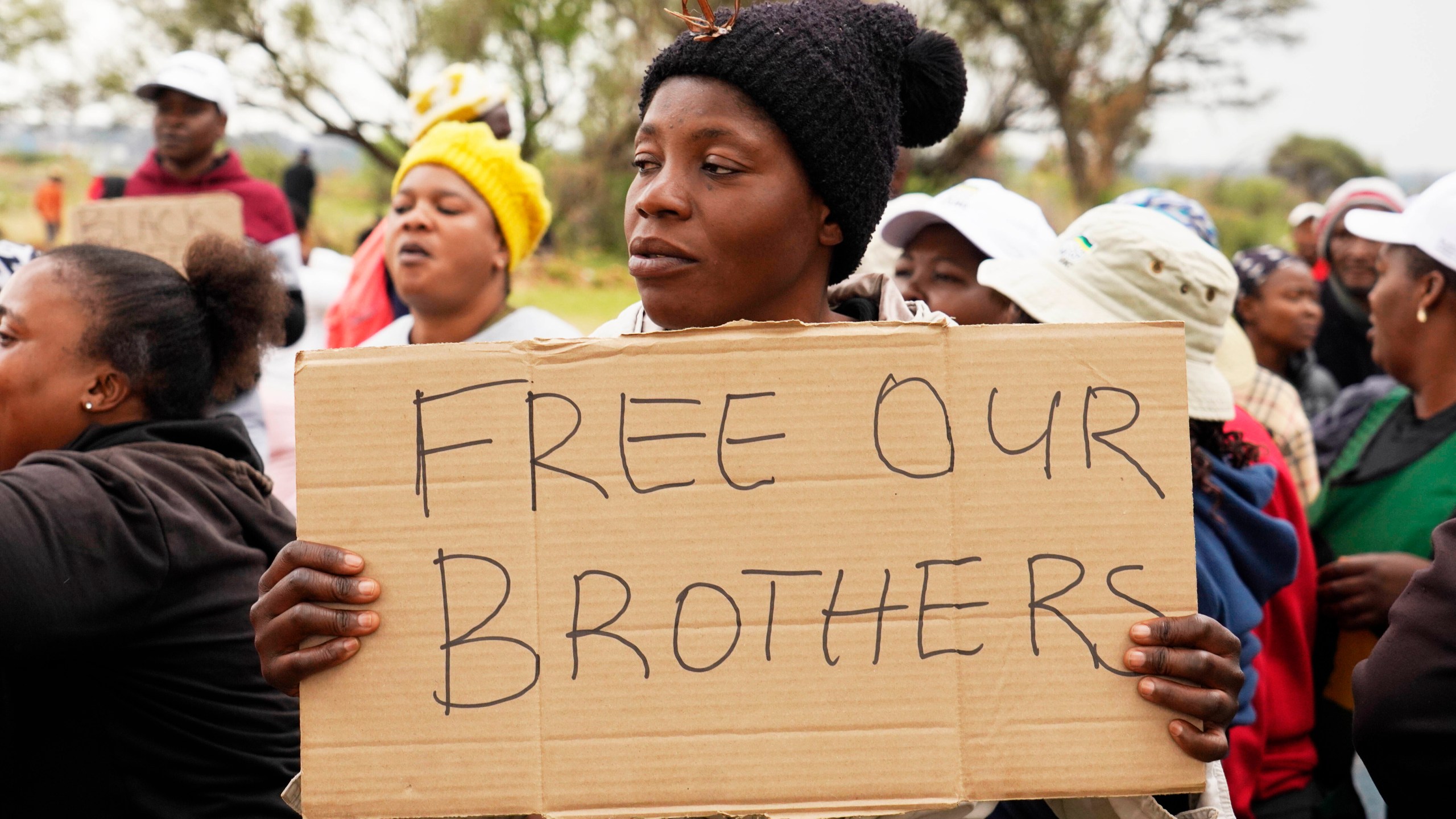 FILE - Relatives and friends protest near a reformed gold mineshaft where illegal miners are trapped in Stilfontein, South Africa, Friday, Nov. 15, 2024. (AP Photo/Denis Farrell, File)