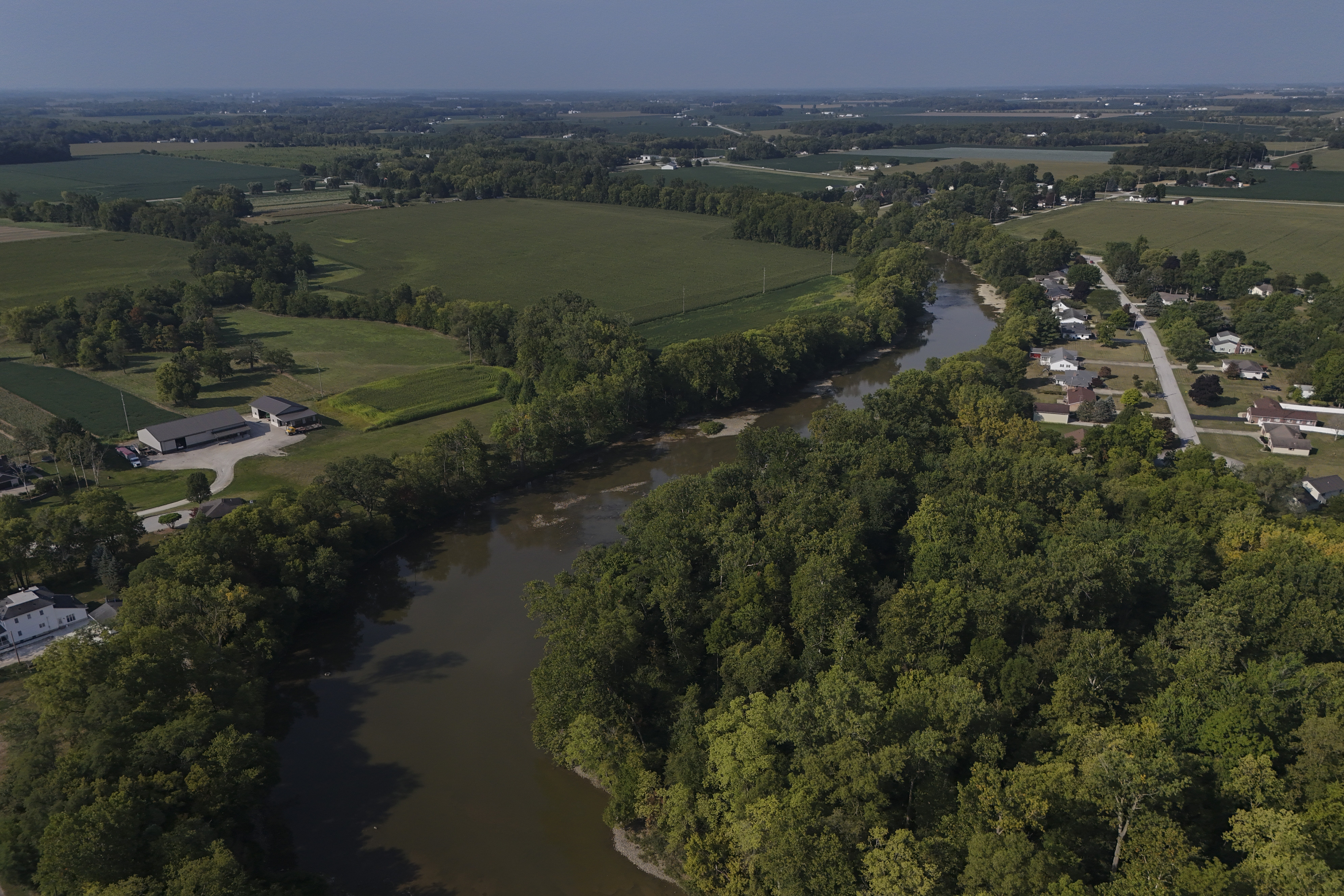 FILE - Water flows down the Sandusky River between farms, Aug. 26, 2024, in Fremont, Ohio. (AP Photo/Joshua A. Bickel, File)