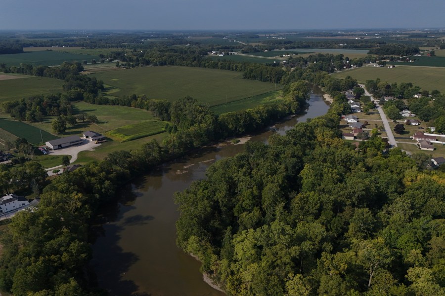 FILE - Water flows down the Sandusky River between farms, Aug. 26, 2024, in Fremont, Ohio. (AP Photo/Joshua A. Bickel, File)