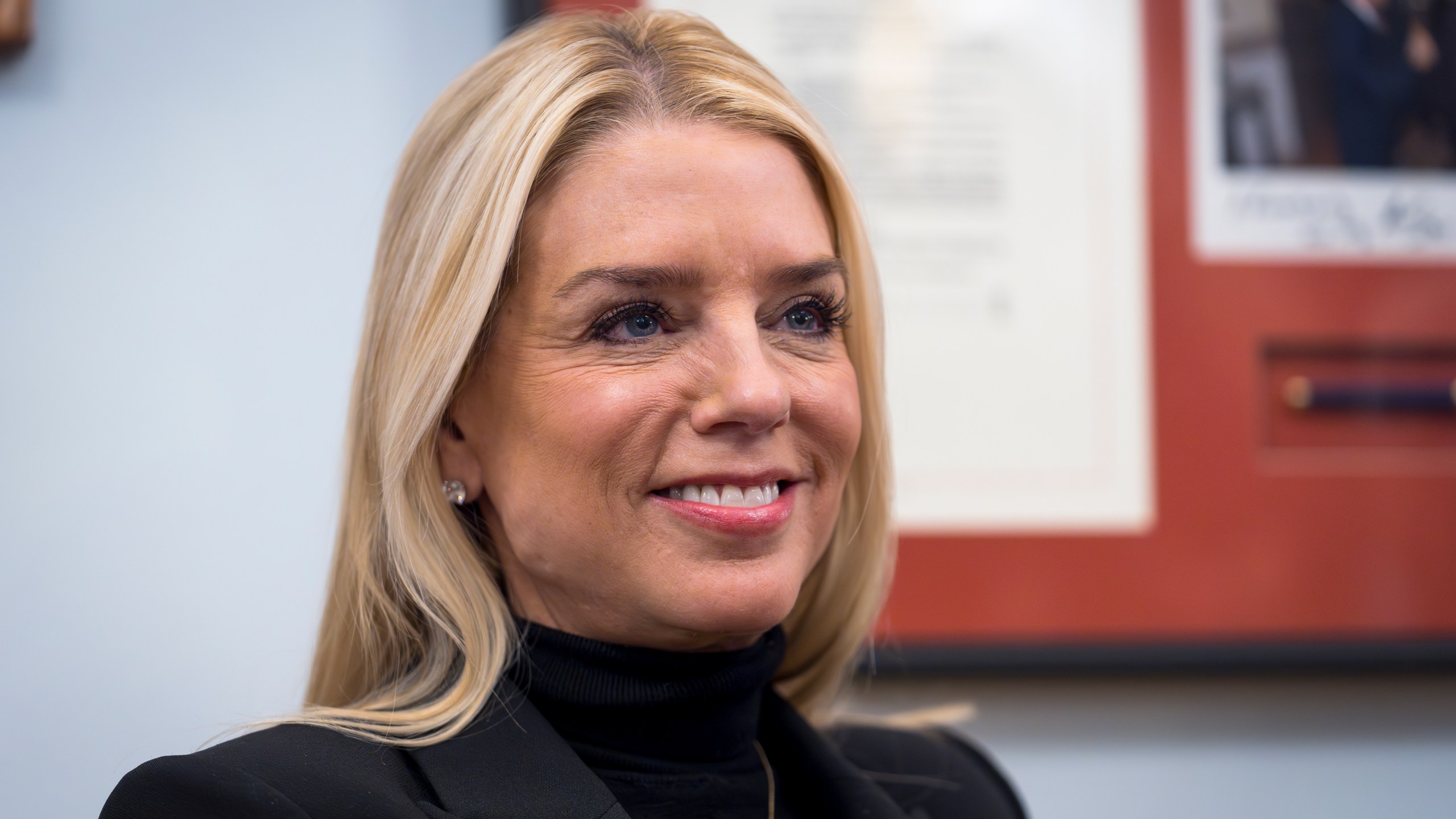 FILE - Pam Bondi, President-elect Donald Trump's nominee for Attorney General, listens during a meeting with Sen. Lindsey Graham, R-S.C., at the Capitol in Washington, Dec. 2, 2024. (AP Photo/J. Scott Applewhite, File)