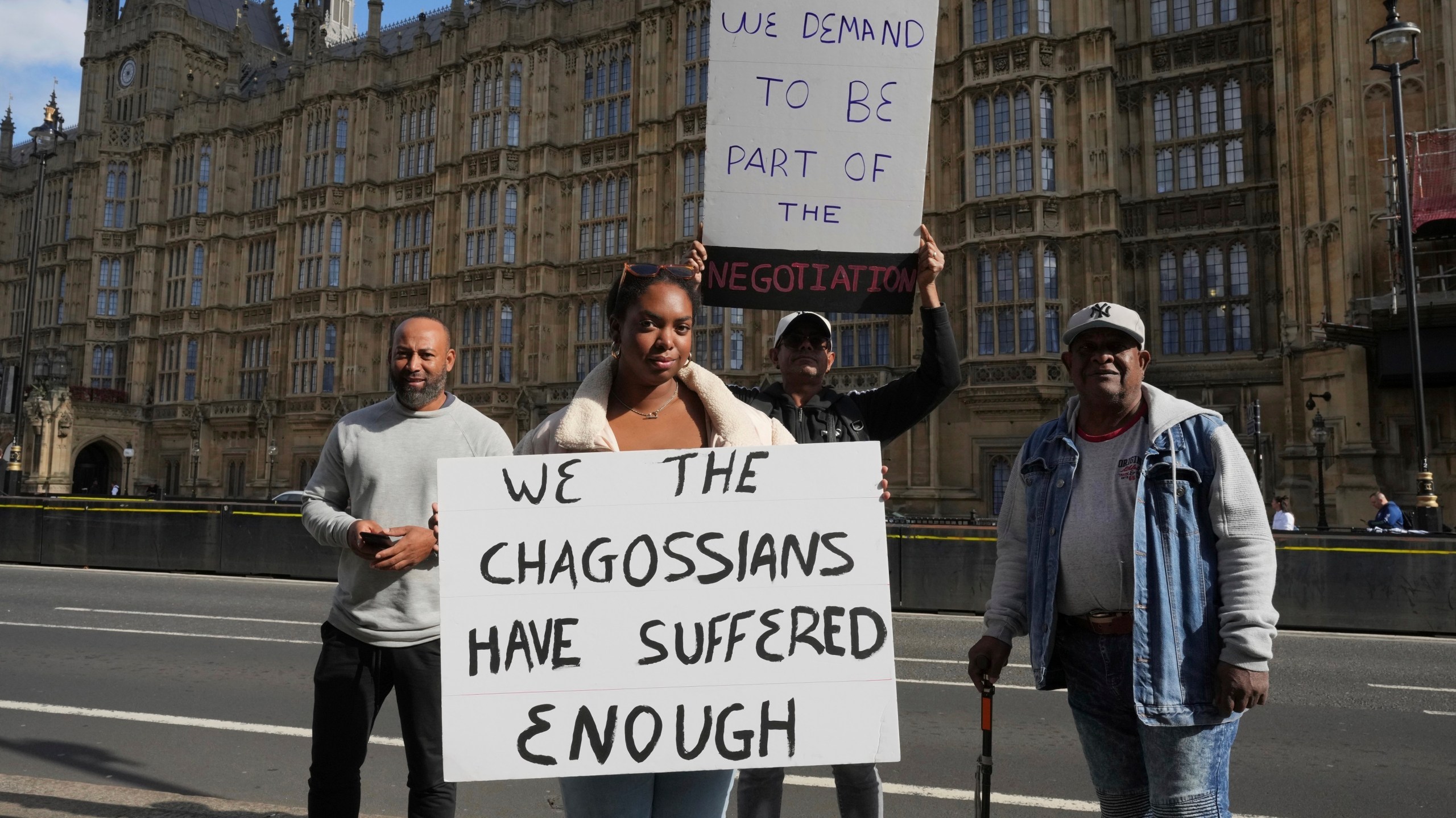 FILE - Chagossians Whitney Tranquille, center, attends a protest outside the House of Parliament, in London, Oct. 7, 2024. (AP Photo/Kin Cheung, file)