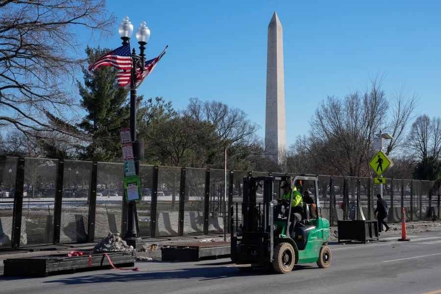 Workers install security fencing around the Ellipse near the White House ahead of the upcoming inauguration of President-elect Donald Trump in Washington, Tuesday, Jan. 14, 2025. (AP Photo/Jon Elswick)