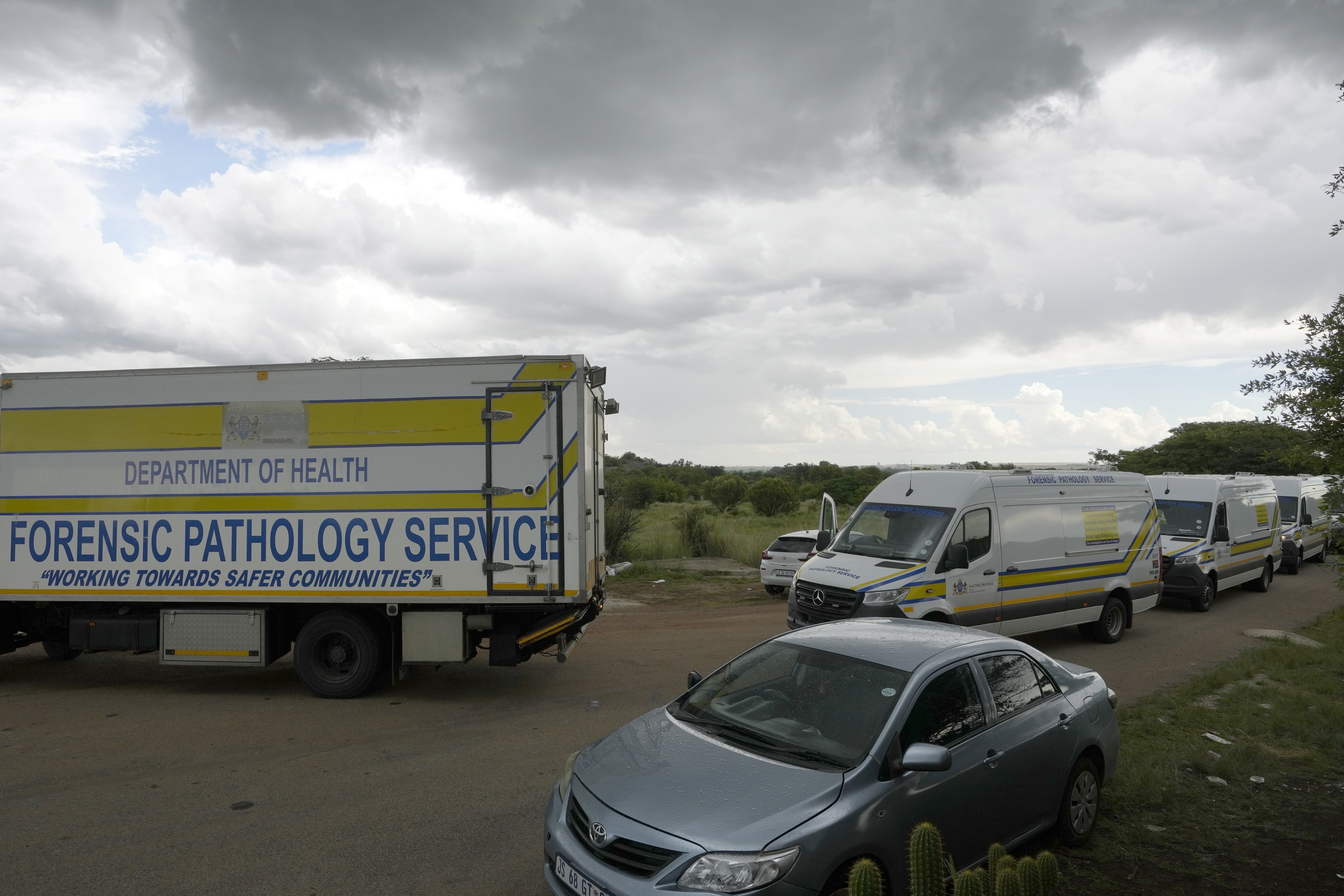 Forensic service vehicles arrive at the site where a rescue operation continues for miners trapped in an abandoned gold mine in Stilfontein, South Africa, Wednesday, Jan. 15, 2025. (AP Photo/Themba Hadebe)