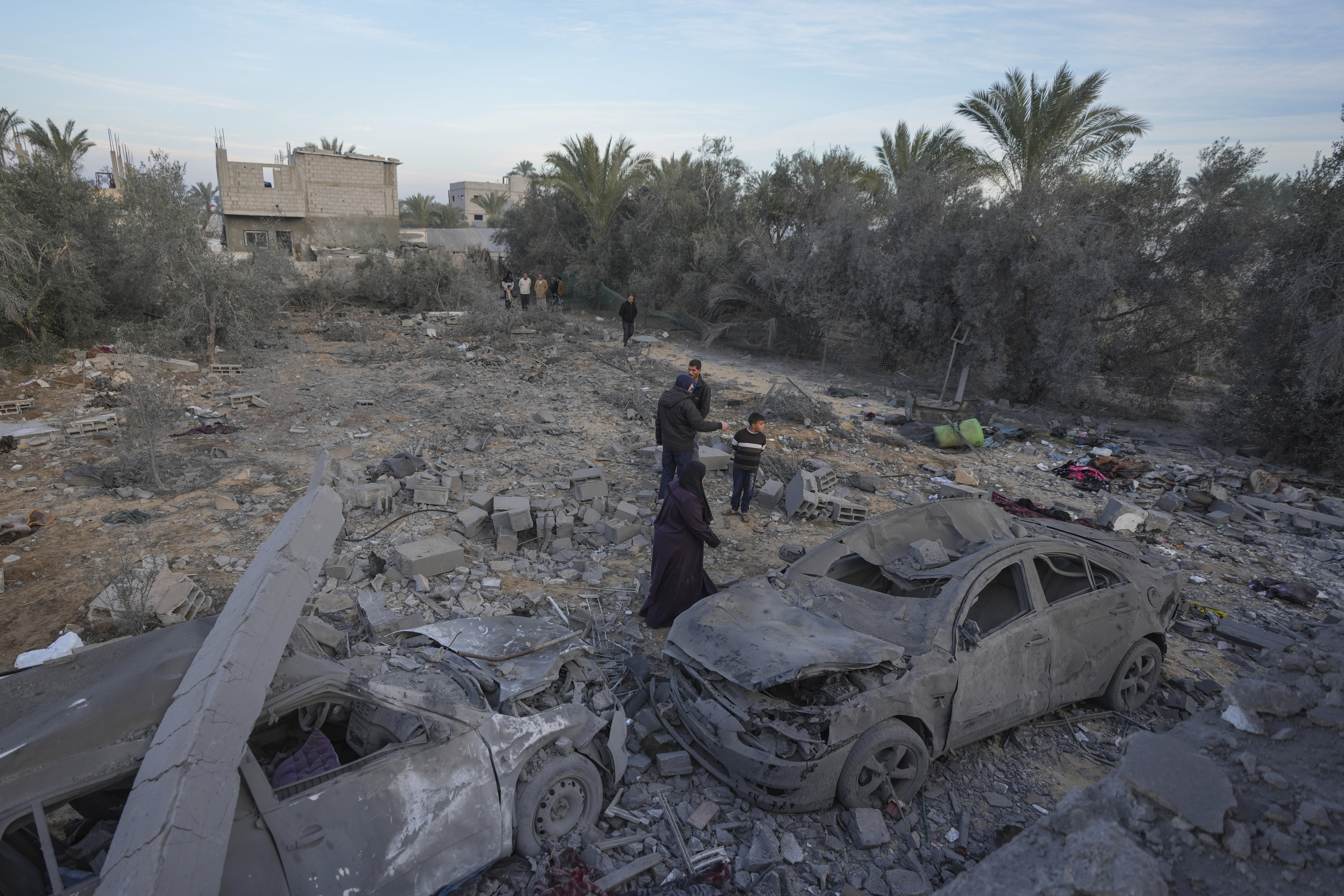 Palestinians inspect the site of an Israeli strike in Deir Al-Balah in the central Gaza Strip, Wednesday, Jan. 15, 2025. (AP Photo/Abdel Kareem Hana)