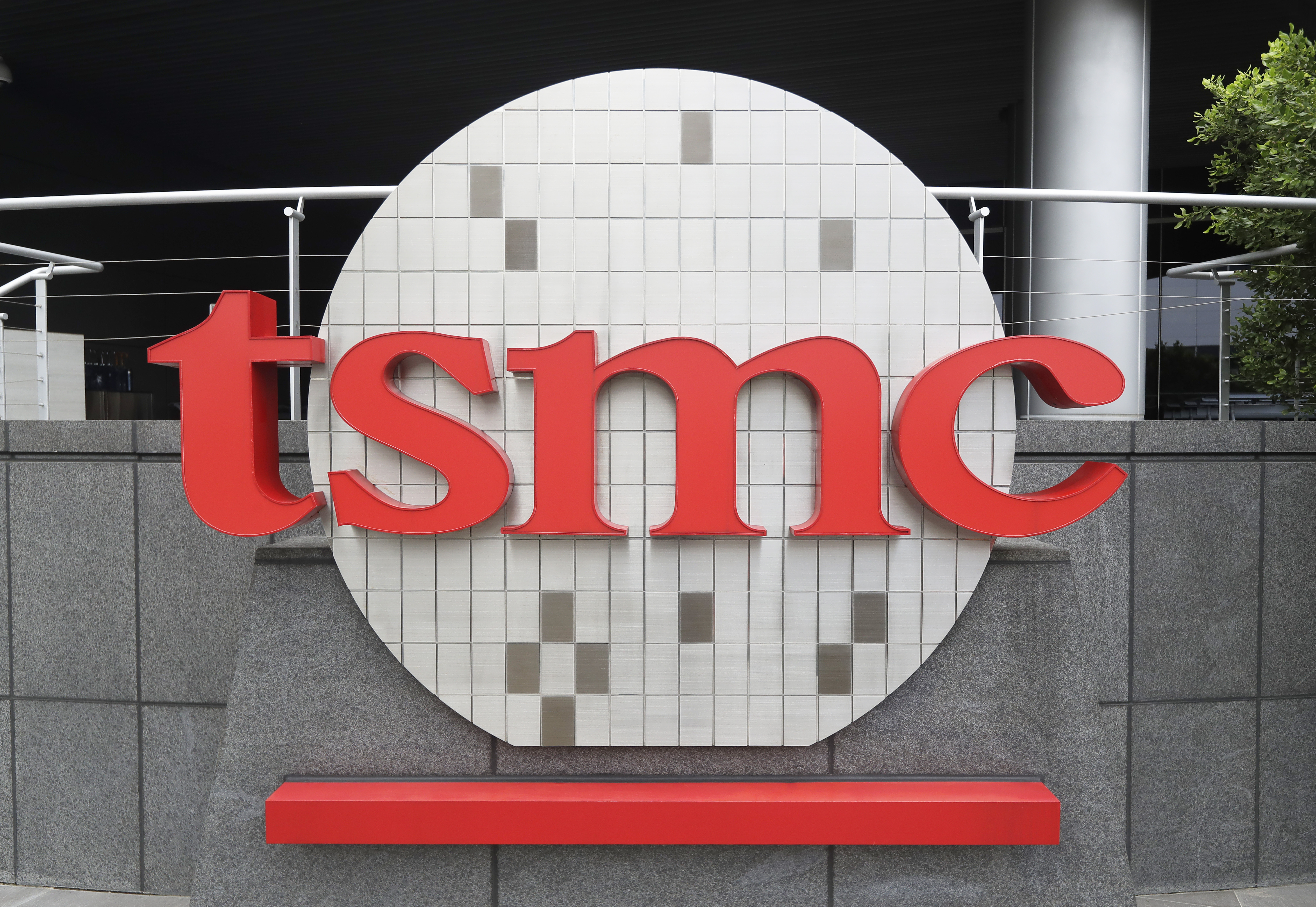 FILE - Taiwan Semiconductor Manufacturing Co., Ltd. (TSMC) logo brands the headquarters in Hsinchu, Taiwan, Wednesday, Oct. 20, 2021. (AP Photo/Chiang Ying-ying, File)