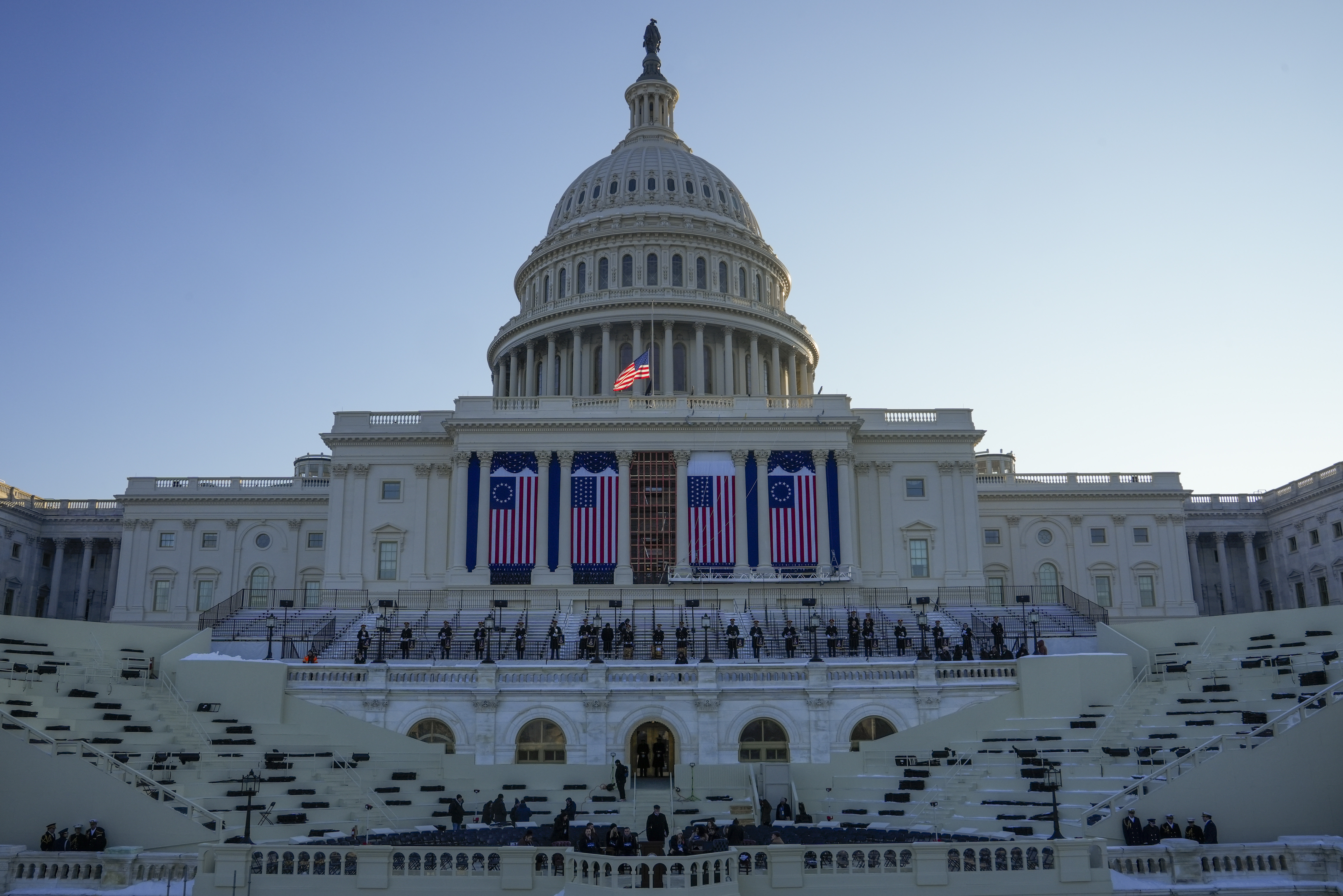 People take their places as a rehearsal begins on the West Front of U.S. Capitol ahead of President-elect Donald Trump's upcoming inauguration, Sunday, Jan. 12, 2025, in Washington. (AP Photo/Jon Elswick)