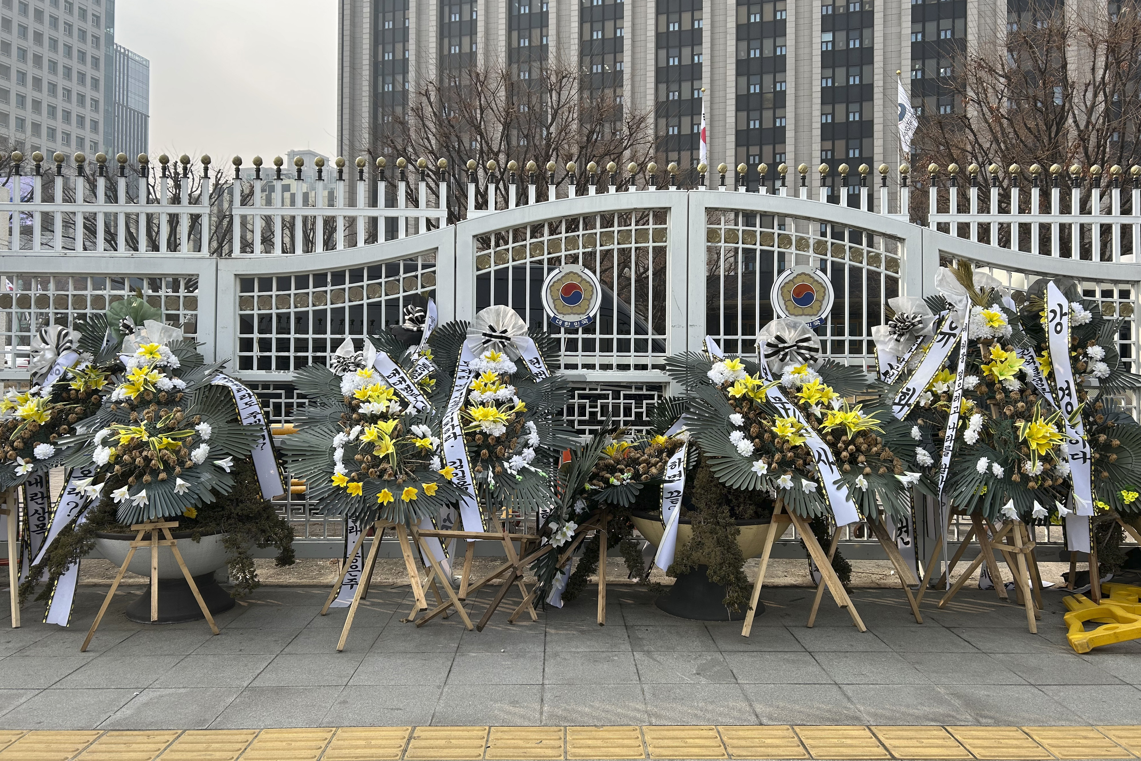 Funeral wreaths bearing messages critical of officials involved in South Korea's martial law controversy stand outside the Government Complex Seoul on Monday, Jan. 20, 2025, in Seoul. (AP Photo/Juwon Park)