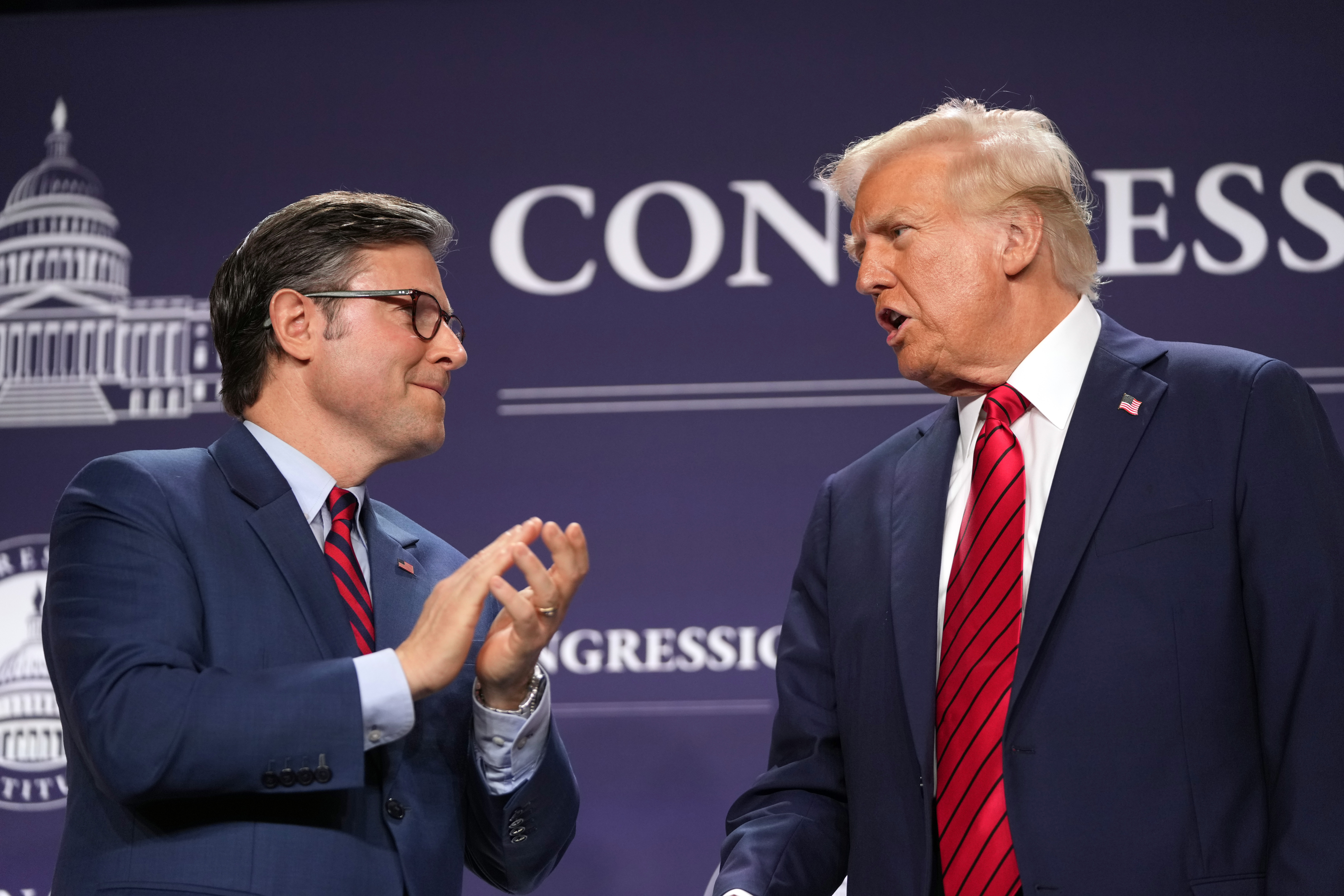 President Donald Trump looks to House Speaker Mike Johnson of La., before he speaks at the 2025 House Republican Members Conference Dinner at Trump National Doral Miami in Doral, Fla., Monday, Jan. 27, 2025. (AP Photo/Mark Schiefelbein)