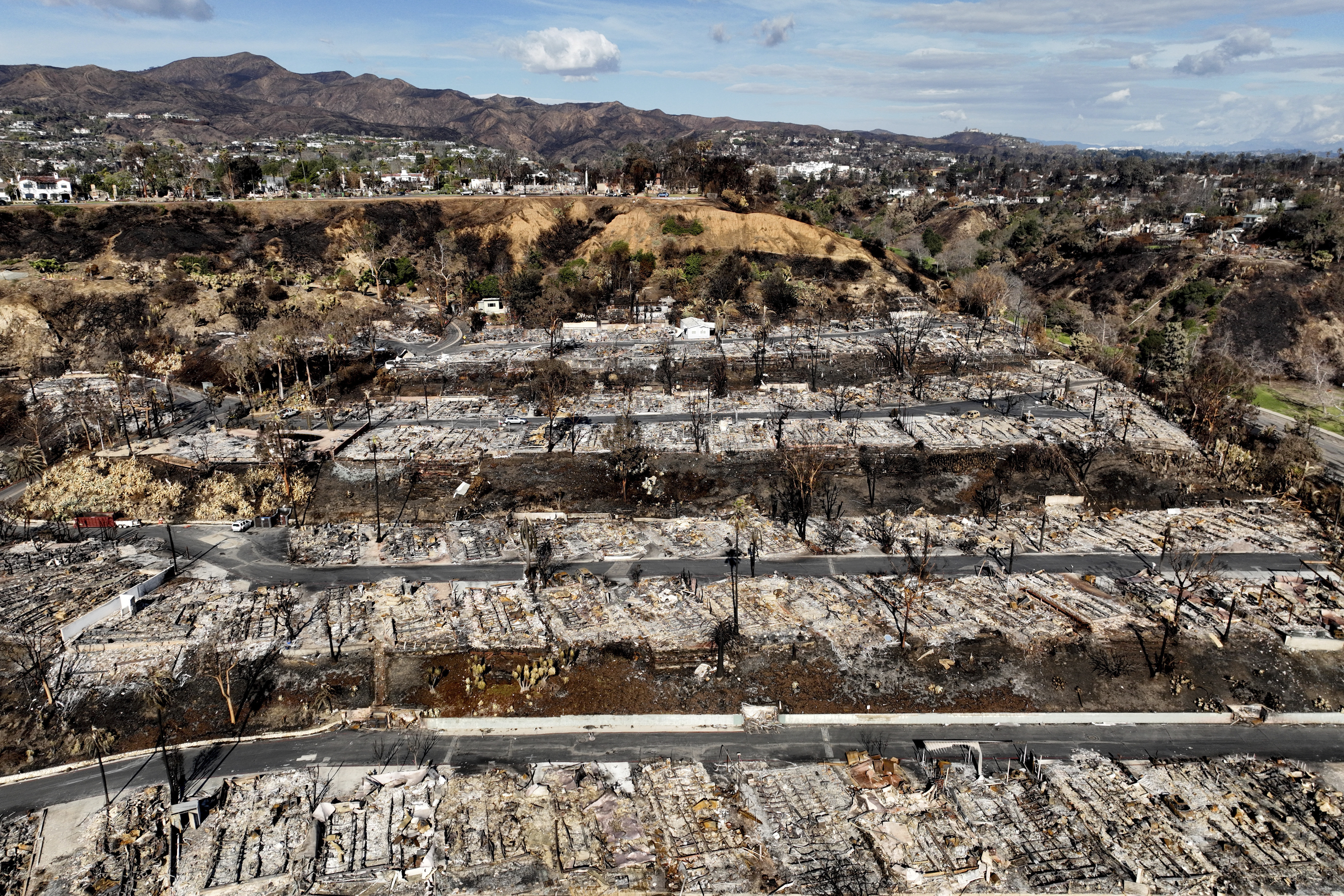 An aerial view shows the devastation left by the Palisades Fire in the Pacific Palisades section of Los Angeles, Monday, Jan. 27, 2025. (AP Photo/Jae C. Hong)