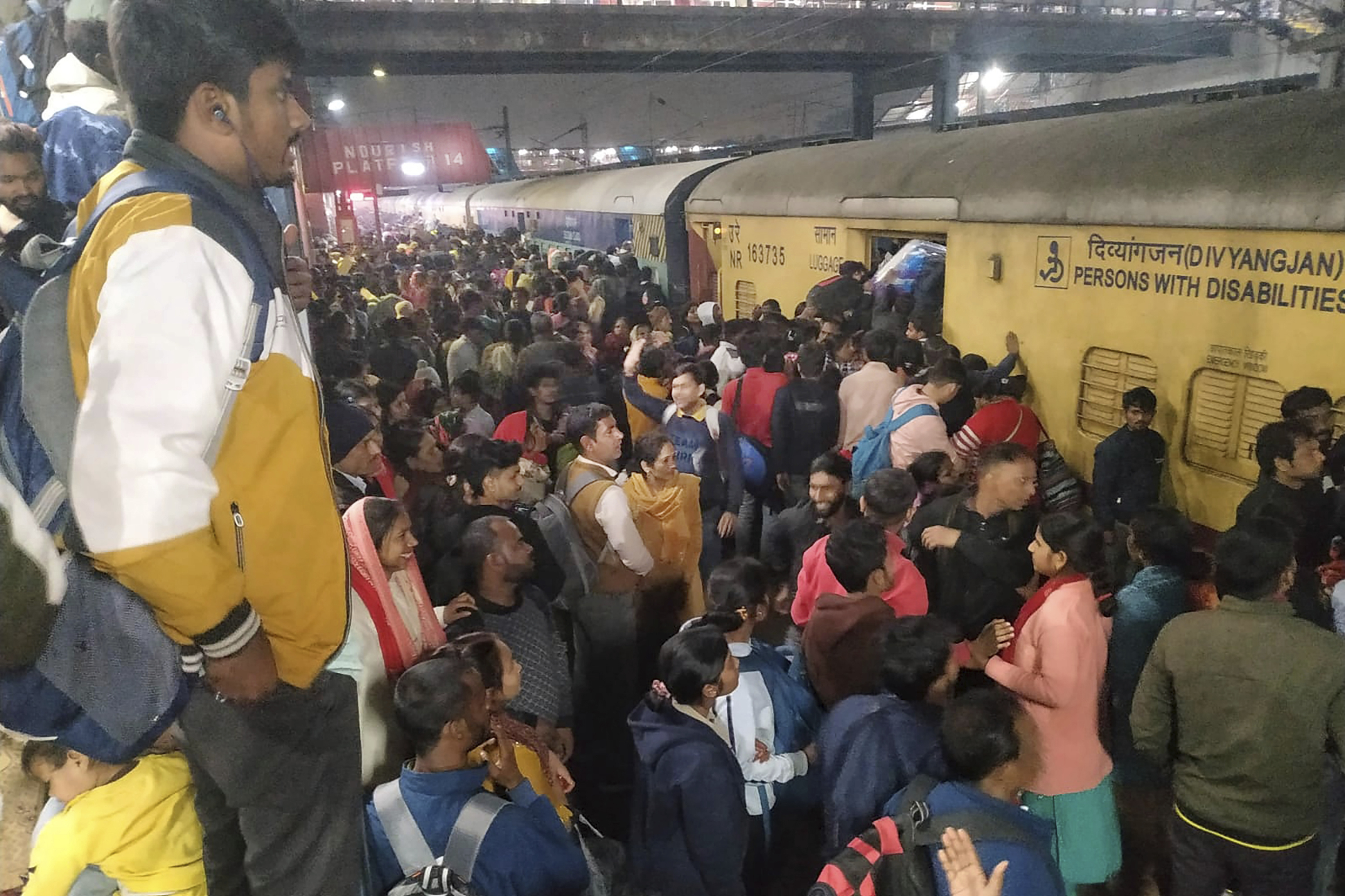 Passengers jostle with each other to board a train at the New Delhi Railway station, in New Delhi, India, Thursday, Feb.15, 2025. (AP Photo)