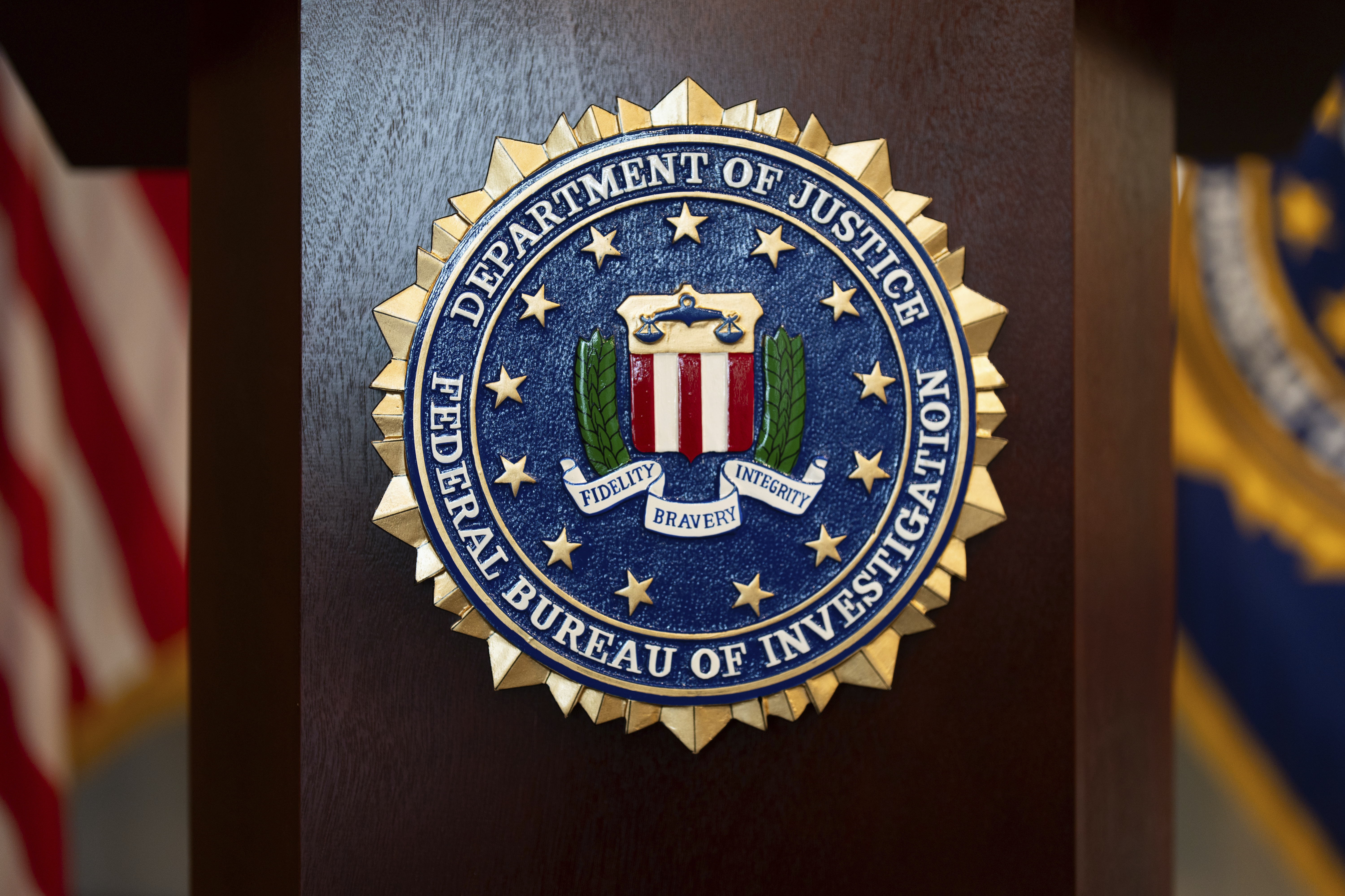 FILE - An FBI seal is displayed on a podium before a news conference at the field office in Portland, Ore., Jan. 16, 2025. (AP Photo/Jenny Kane, File)