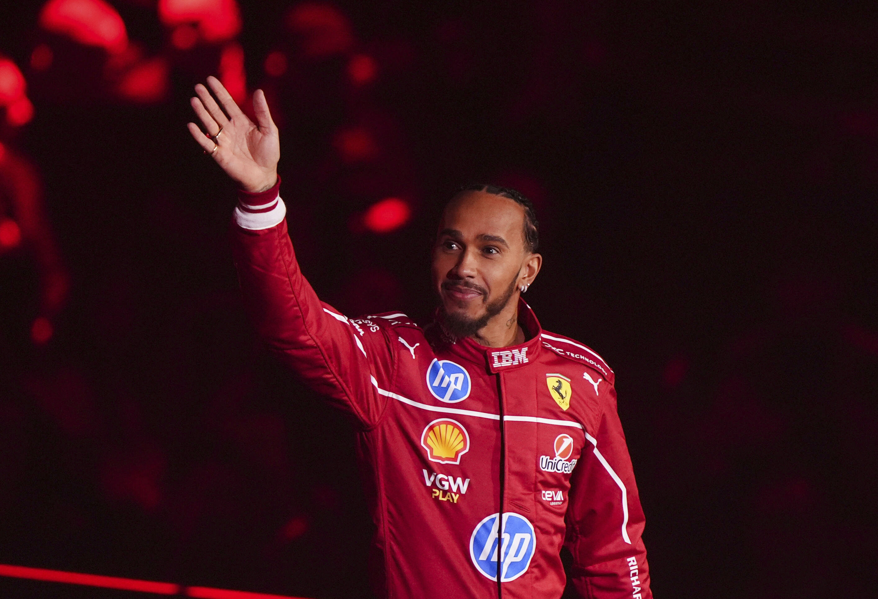 Ferrari driver Lewis Hamilton waves during the F1 75 Live event at the O2 arena in London, England, Tuesday, Feb. 18, 2025. (Bradley Collyer/PA via AP)