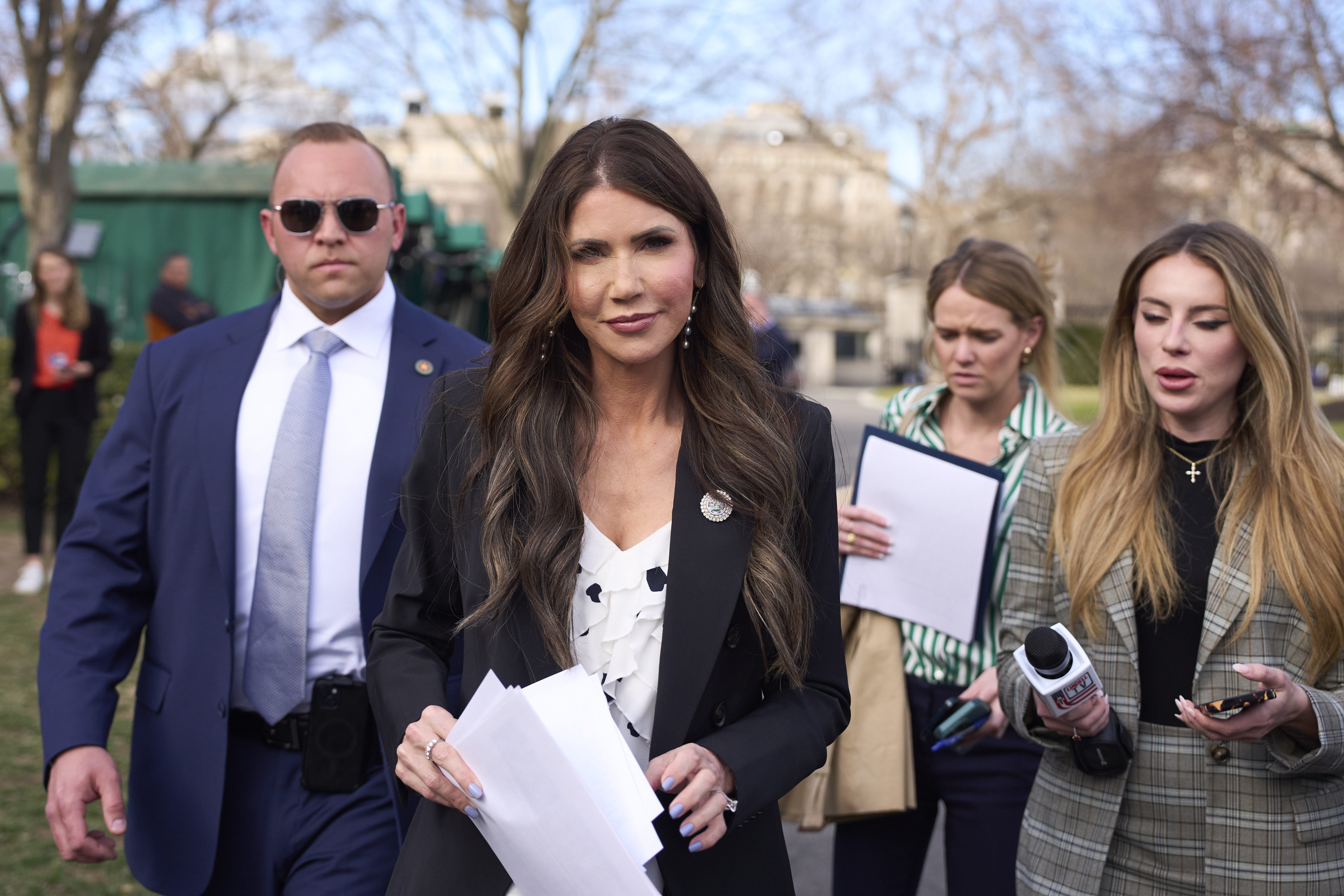 Homeland Security Secretary Kristi Noem walks past journalists at the White House, Monday, March 10, 2025, in Washington. (AP Photo/Alex Brandon)