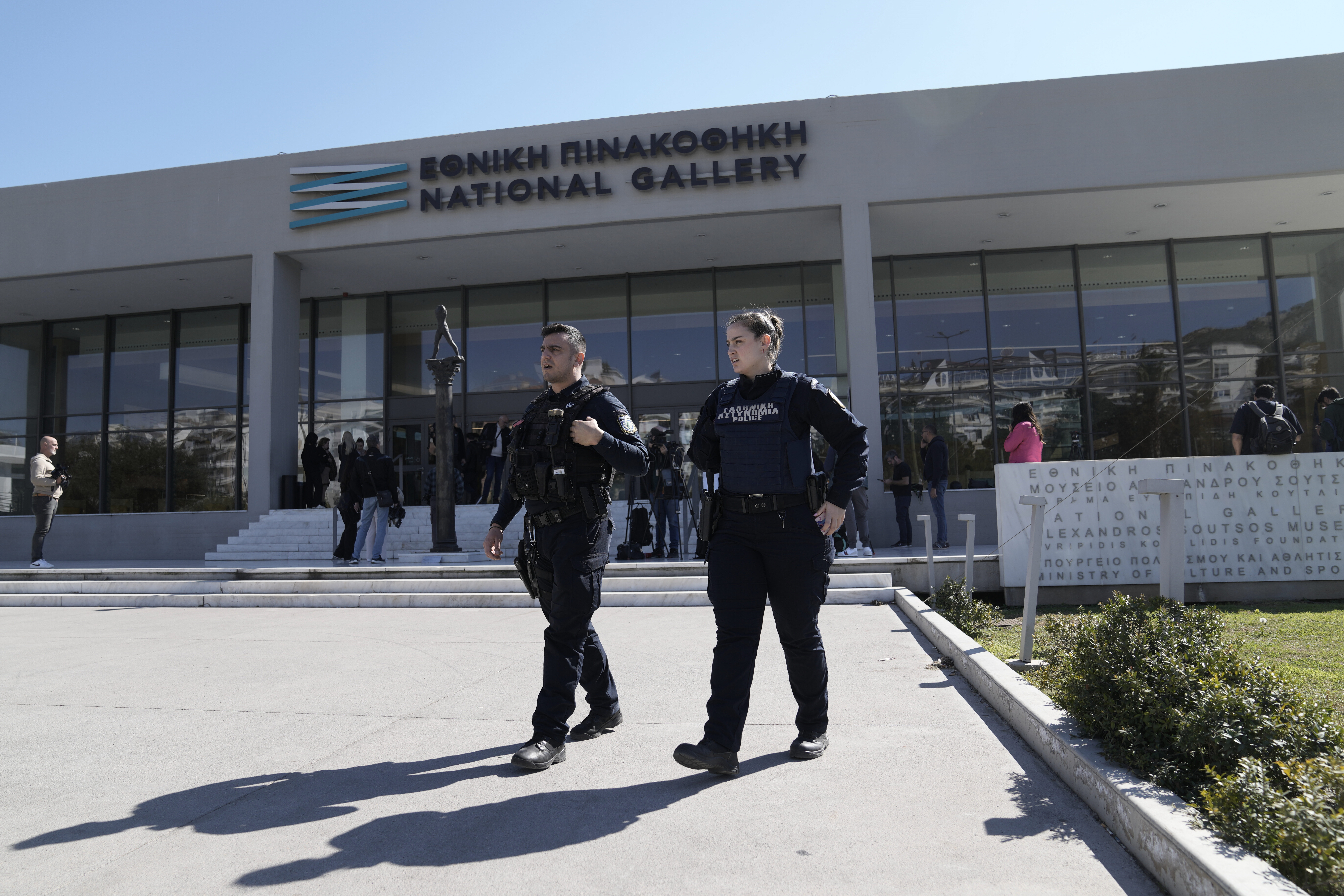 Greek police officers walk outside the National Gallery, as Nikolaos Papadopoulos, member of parliament of the small right-wing Niki party has detained after he allegedly attacked art works being hosted at an exhibition, in Athens, Greece, Monday, March 10, 2025. (AP Photo/Thanassis Stavrakis)