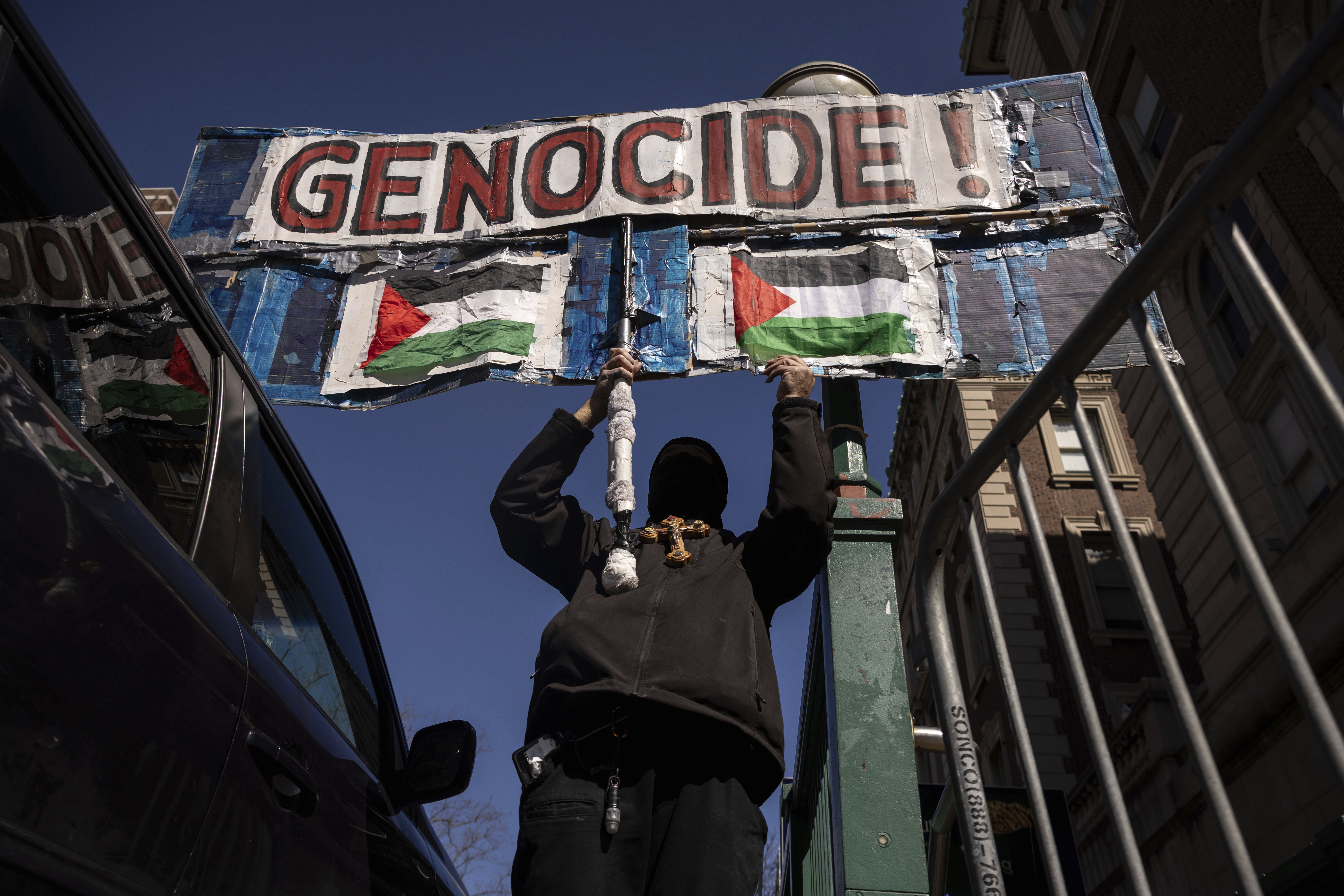 A protester raises a sign during their demonstration in support of Palestinian activist Mahmoud Khalil outside Columbia University, Monday, March 10, 2025, in New York. (AP Photo/Yuki Iwamura)