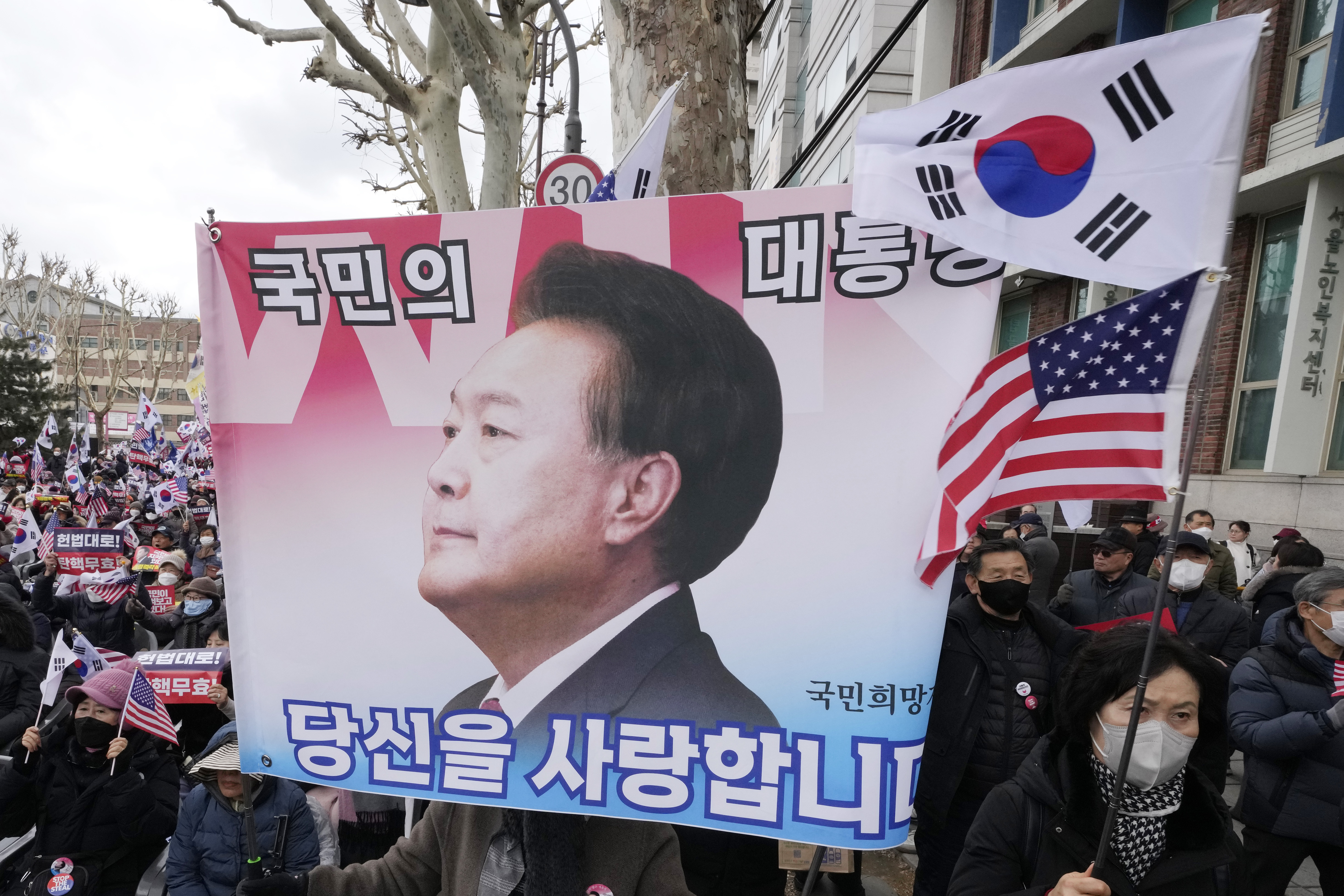 FILE - Supporters of impeached South Korean President Yoon Suk Yeol attend a rally to oppose his impeachment near the Constitutional Court in Seoul, South Korea, on Feb. 25, 2025. The letters read "The people's president." (AP Photo/Ahn Young-joon, File)