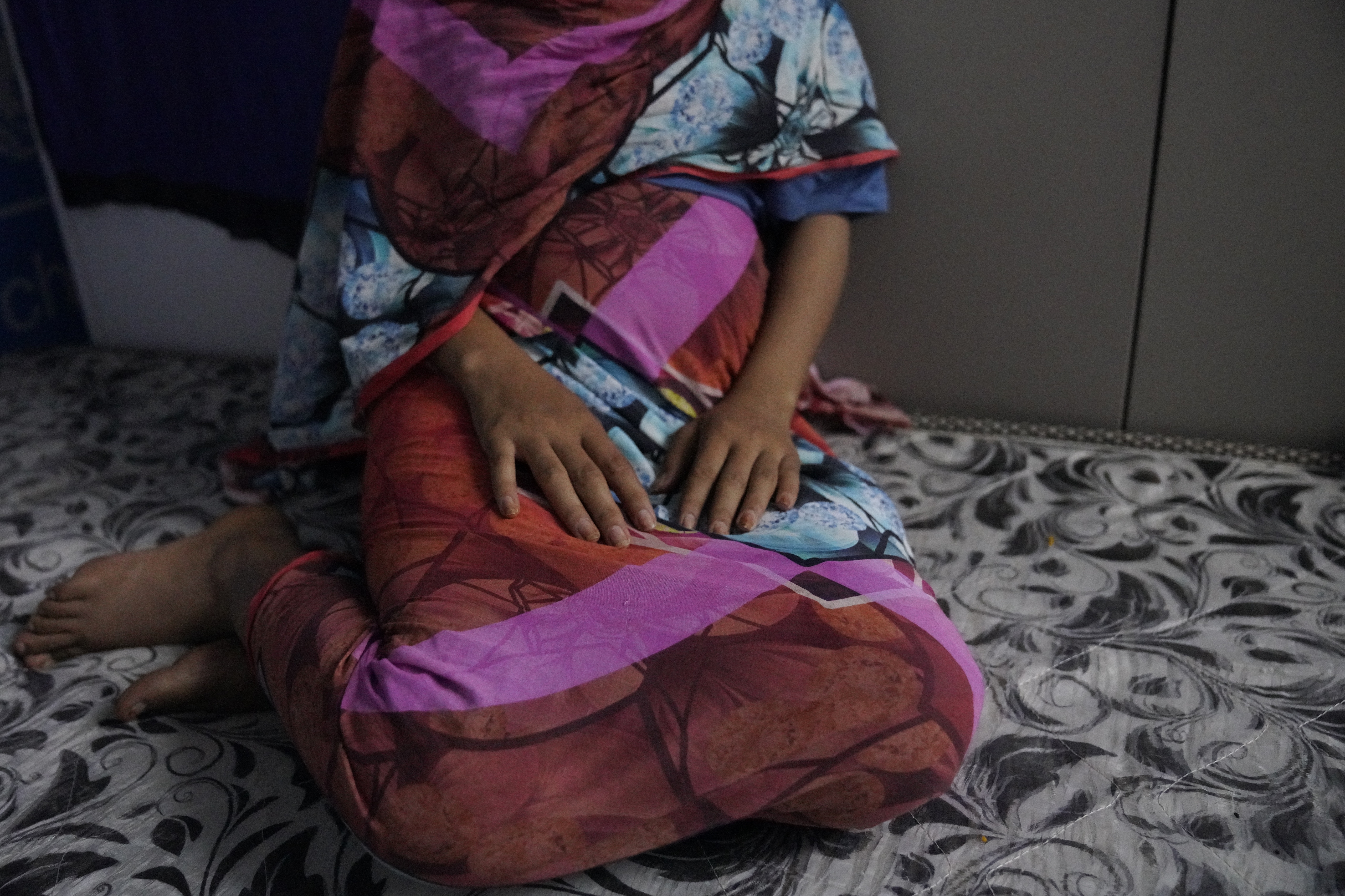 In this photograph released by UNICEF, a 16-year rape victim rests on a mattress at a UNICEF office in Sudan, Dec. 2, 2024. According to UNICEF, the girl and her 19- year- old sister, were kidnapped, beaten and raped by soldiers for four months, before they escaped and later learned they were both pregnant.(Tess Ingram/UNICEF via AP)